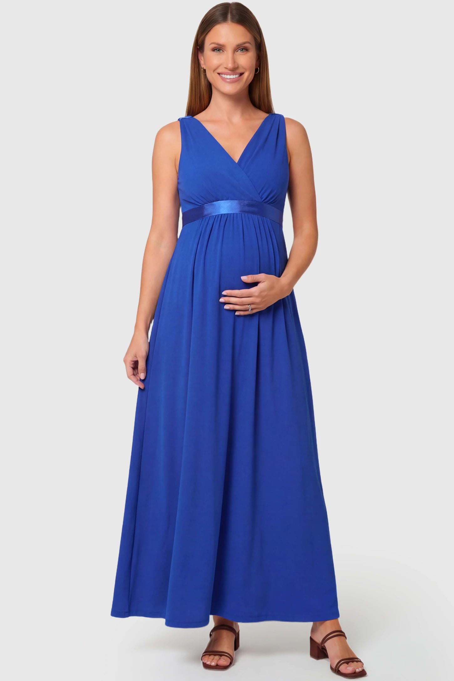 Sleeveless Faux Wrap Maternity & Nursing Maxi Dress in royal blue featuring V-neckline and empire waist on a pregnant model.