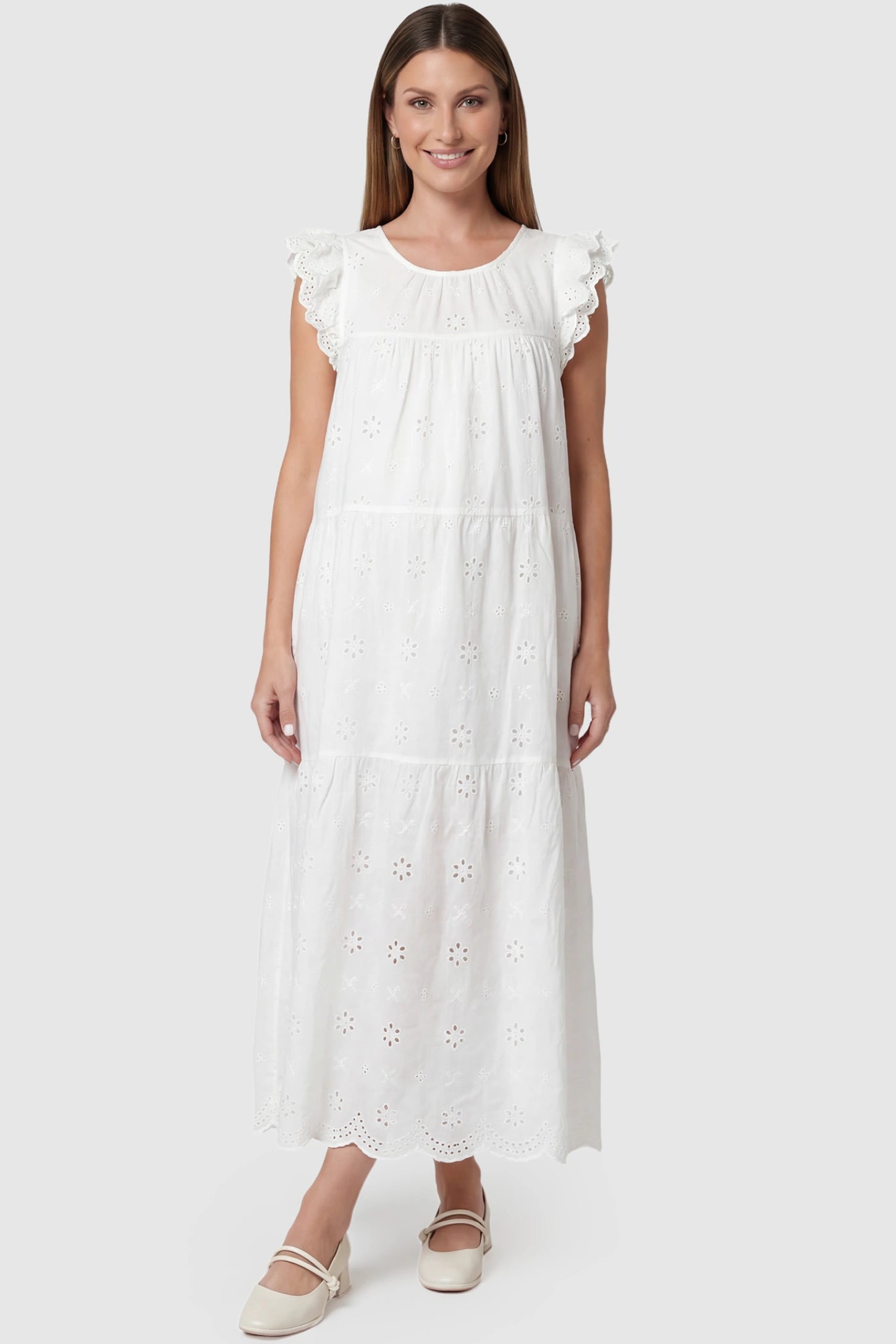 Anglaise lace ruffled sleeve tiered maternity maxi dress in white with delicate lace detail, front view on pregnant model