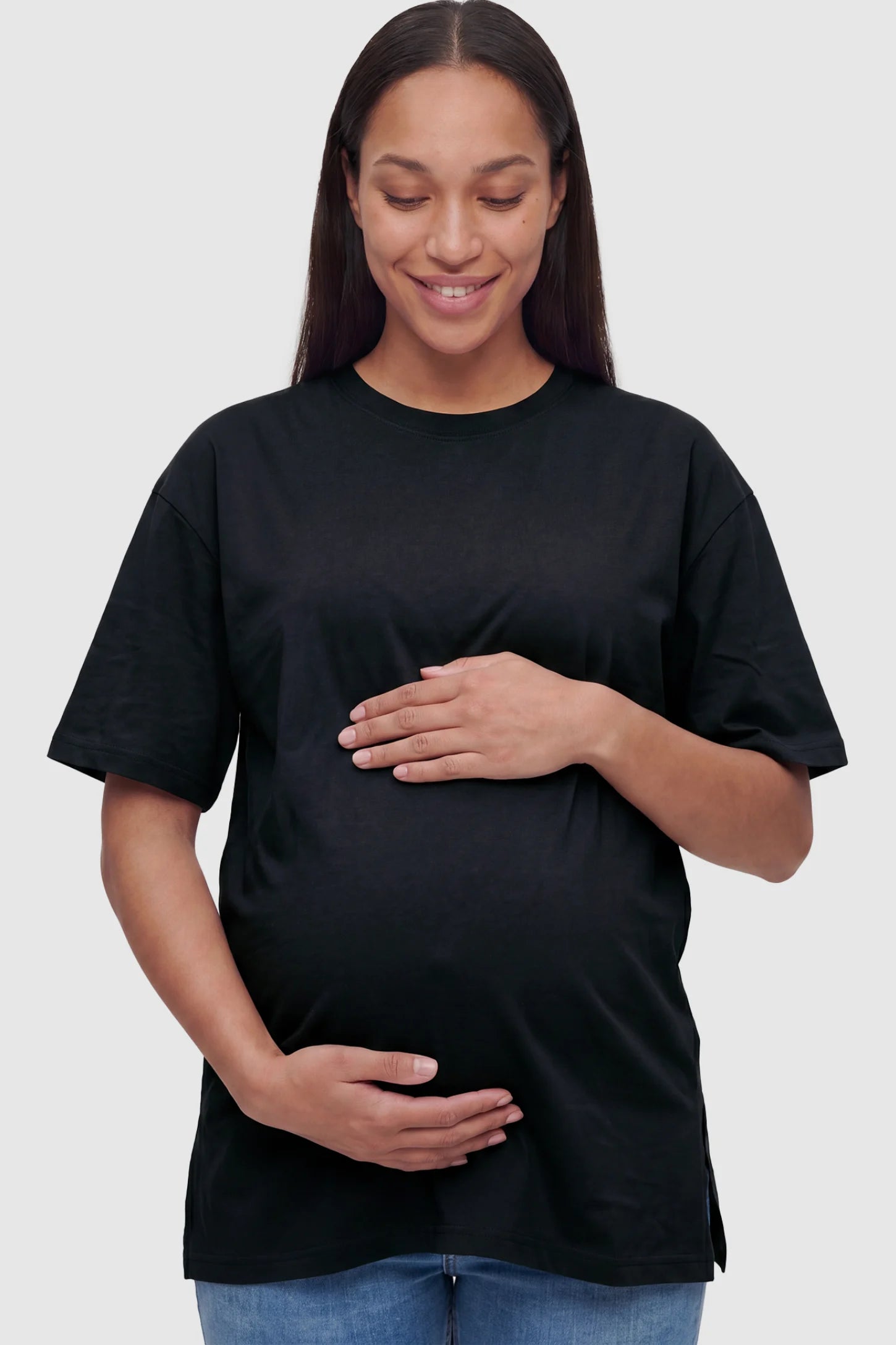 Basic one-sided slit short sleeve maternity top in black with classic round neckline, front view on pregnant model