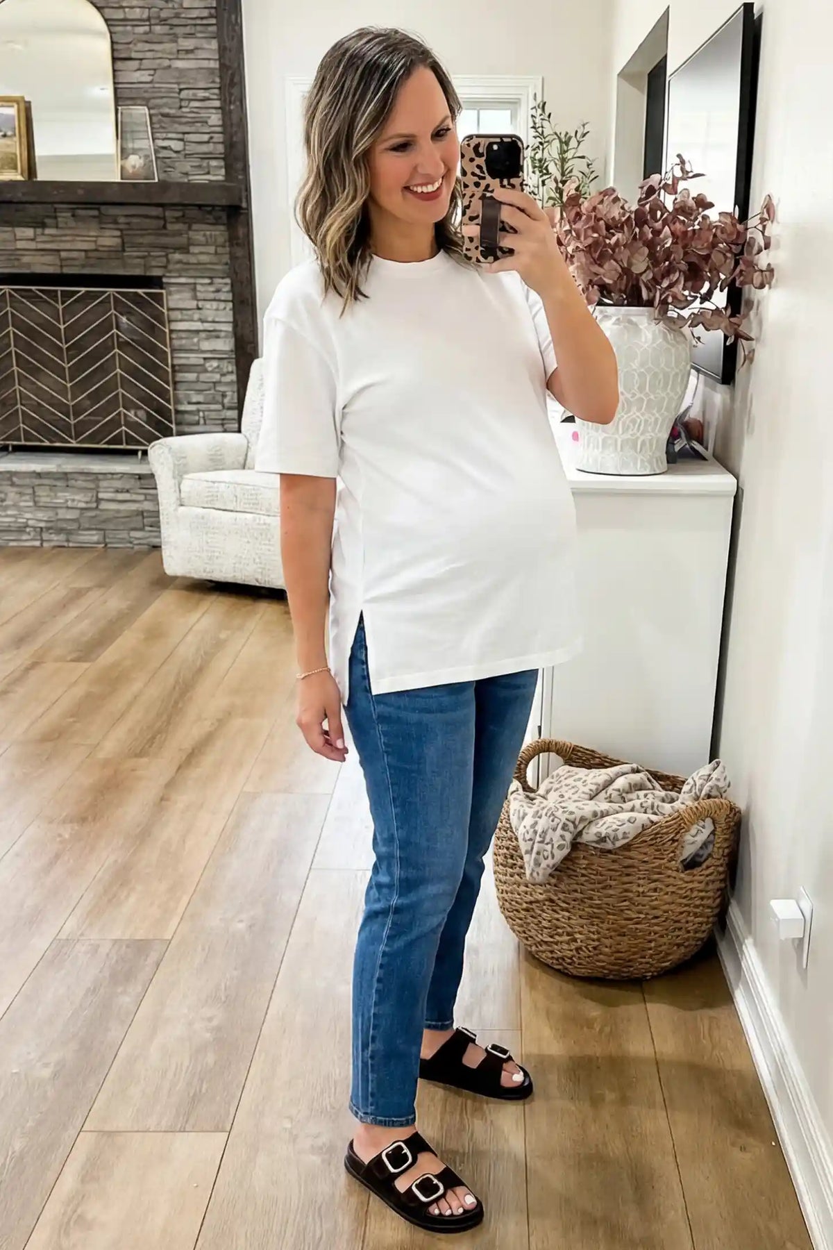 Basic one-sided slit short sleeve maternity top in white with classic round neckline and short sleeves, front view on pregnant model