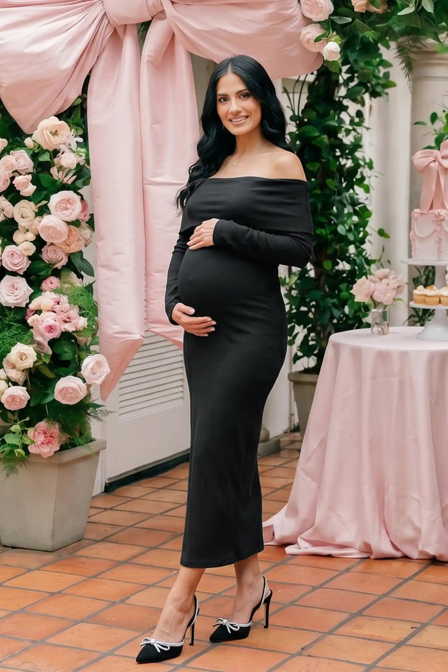 Ruched off-shoulder bodycon maternity midi dress in black with off-shoulder neckline, front view on pregnant model