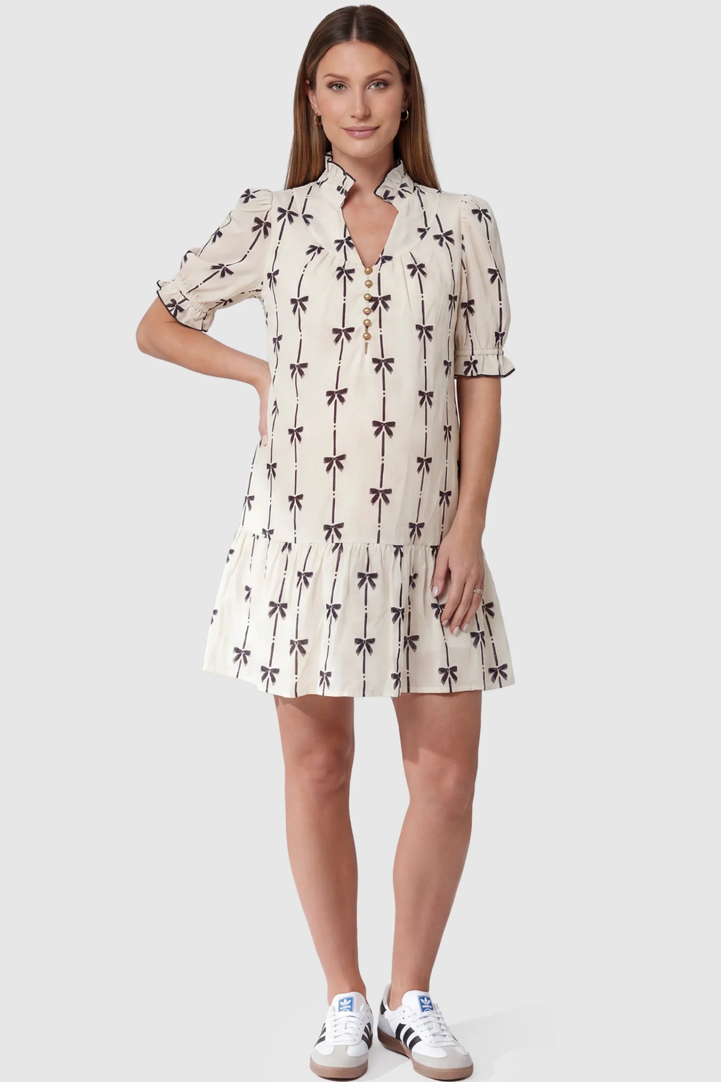 Bowknot print button-up neck maternity short dress in beige with bowknot print detail, front view on pregnant model