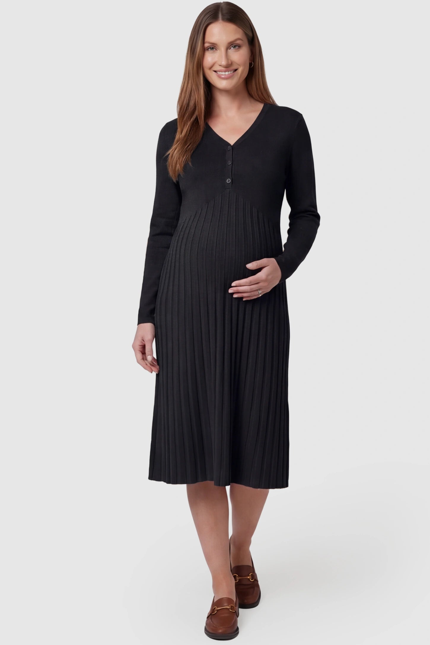 Button-up empire waist maternity midi dress in black with button-up front detail, front view on pregnant model