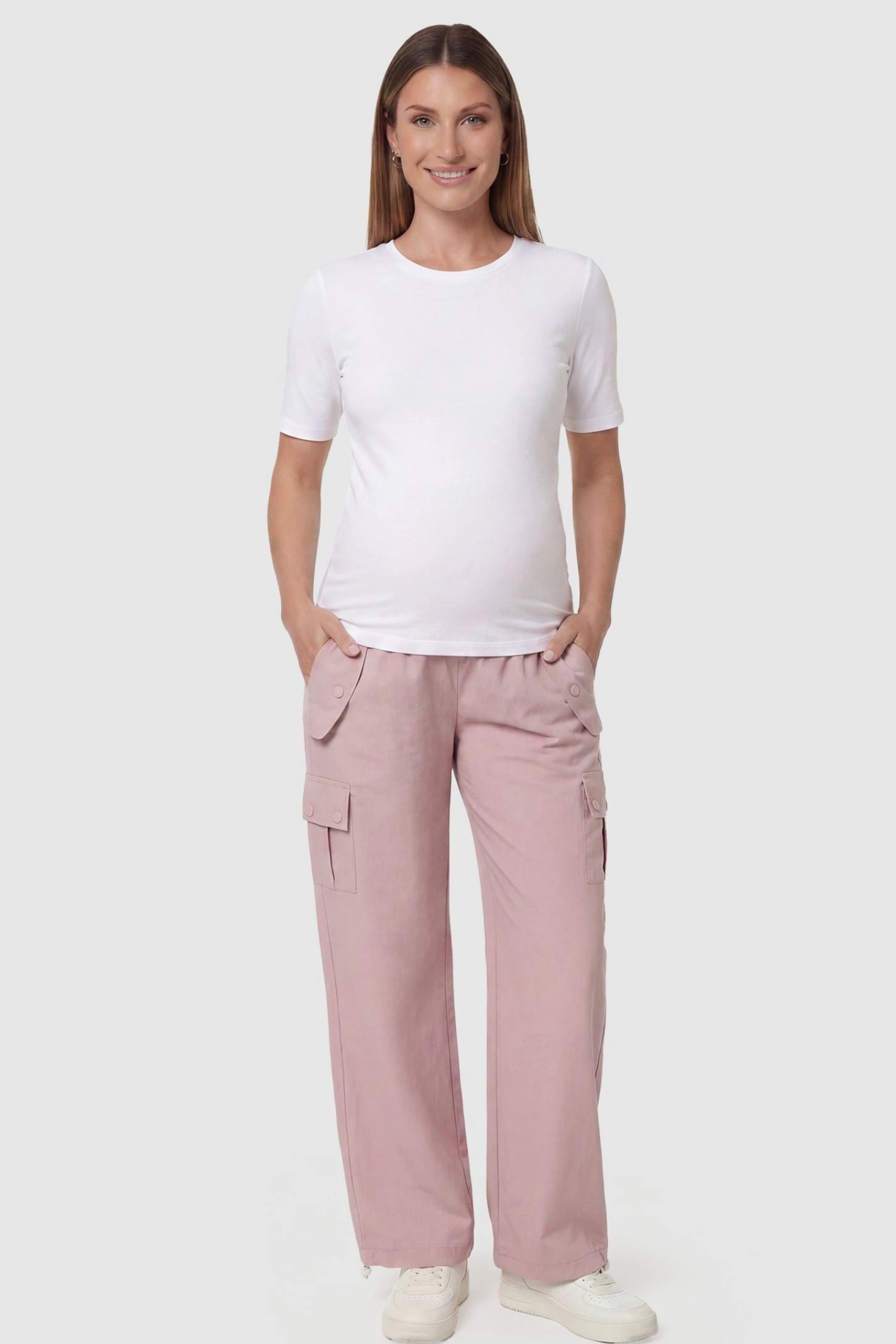 Ice Silk Cargo Maternity Pants in pink featuring full belly panel, cargo pockets, and relaxed full-length fit on pregnant model front view.