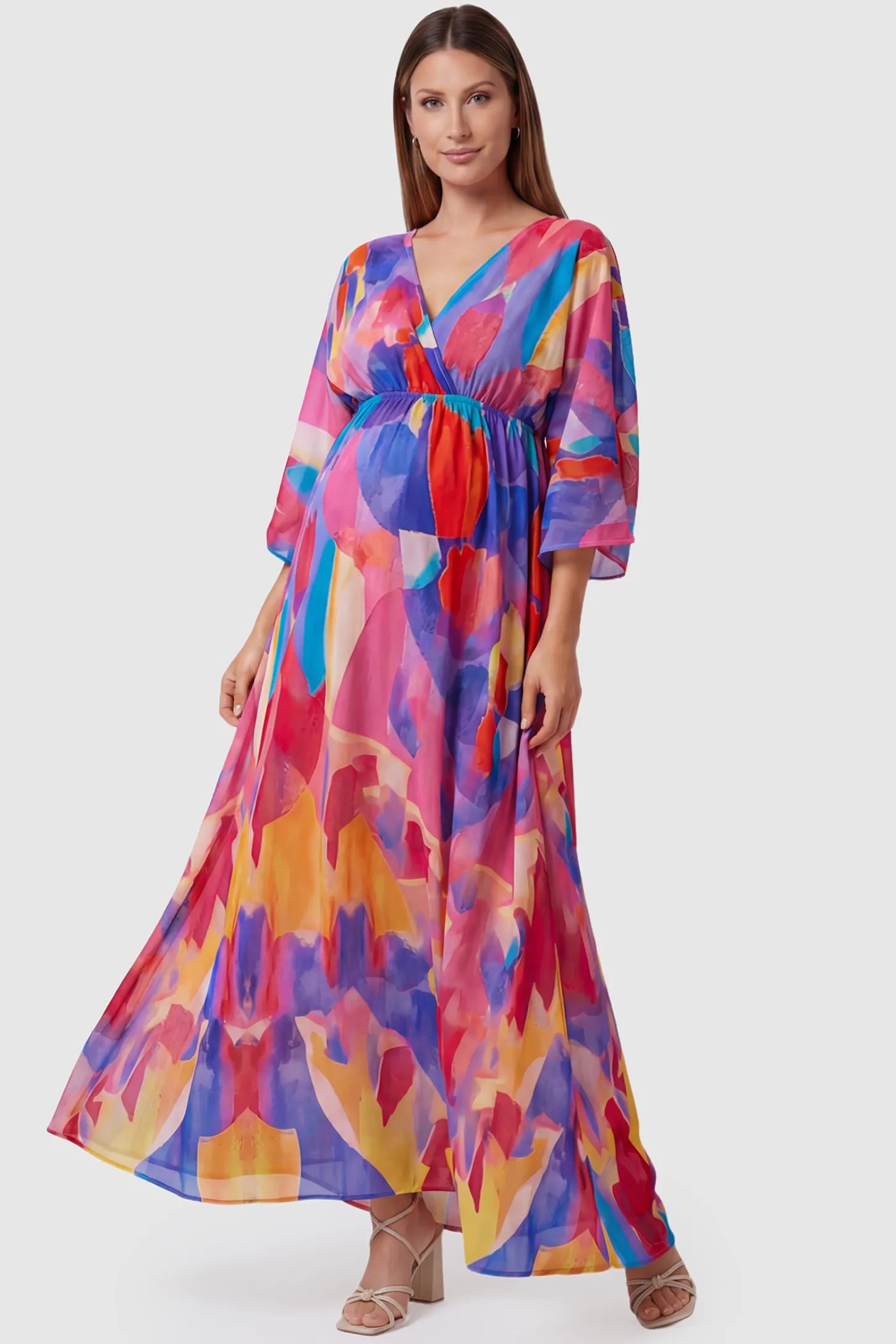 Abstract print V-neck empire waist maxi maternity dress in multicolor with flowing chiffon, full body on pregnant model