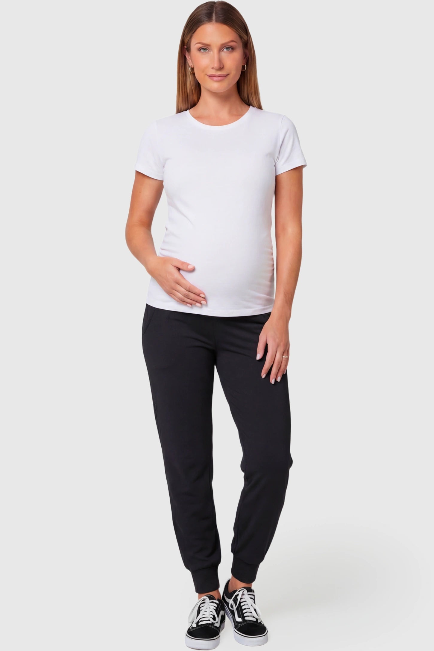 High-Rise Cuffed Maternity Joggers in black featuring ribbed cuff hem on pregnant model.
