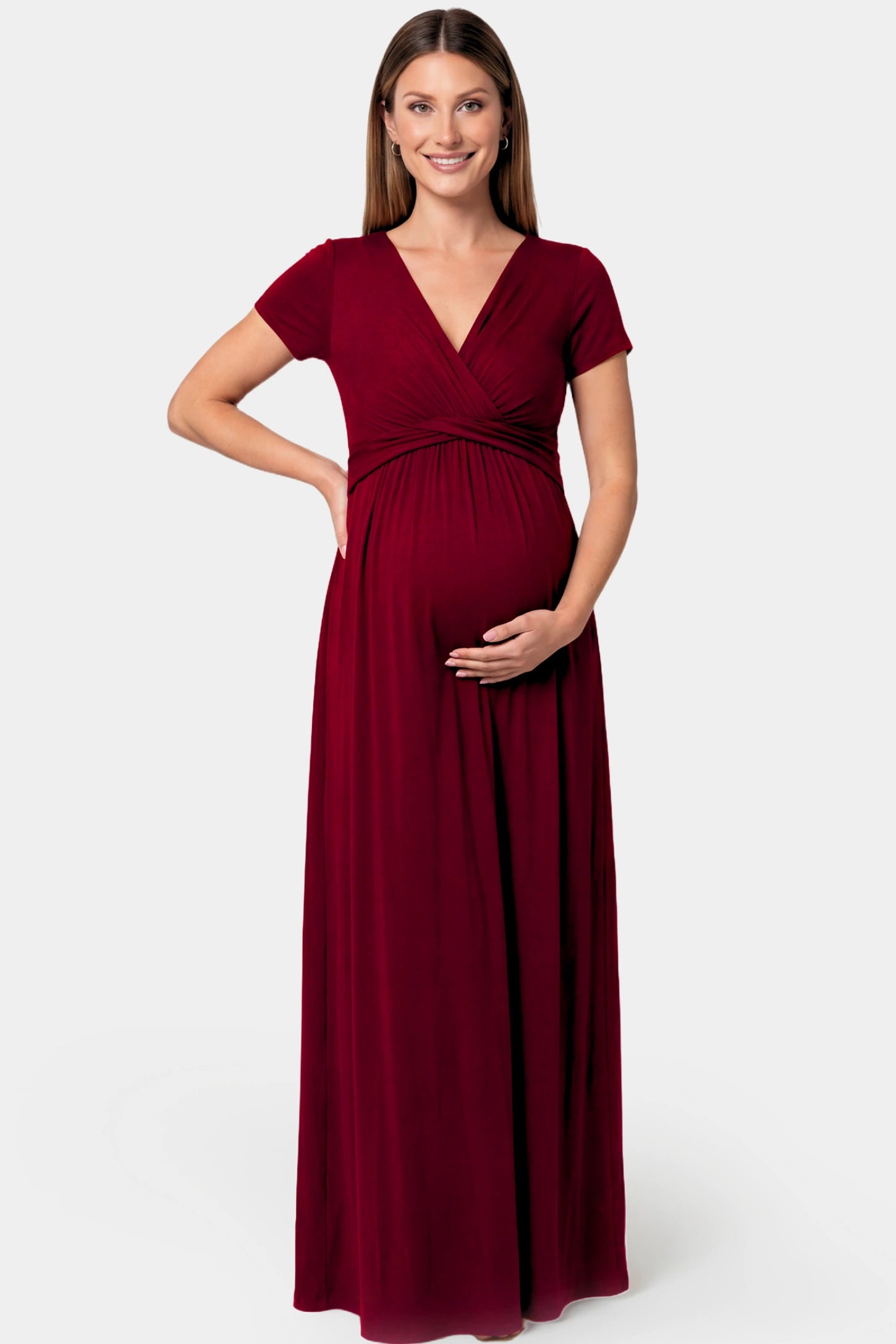 Crossover Draped Maternity & Nursing Maxi Dress in red wine featuring a V-neck crossover design and flowy empire waist silhouette on a pregnant model.
