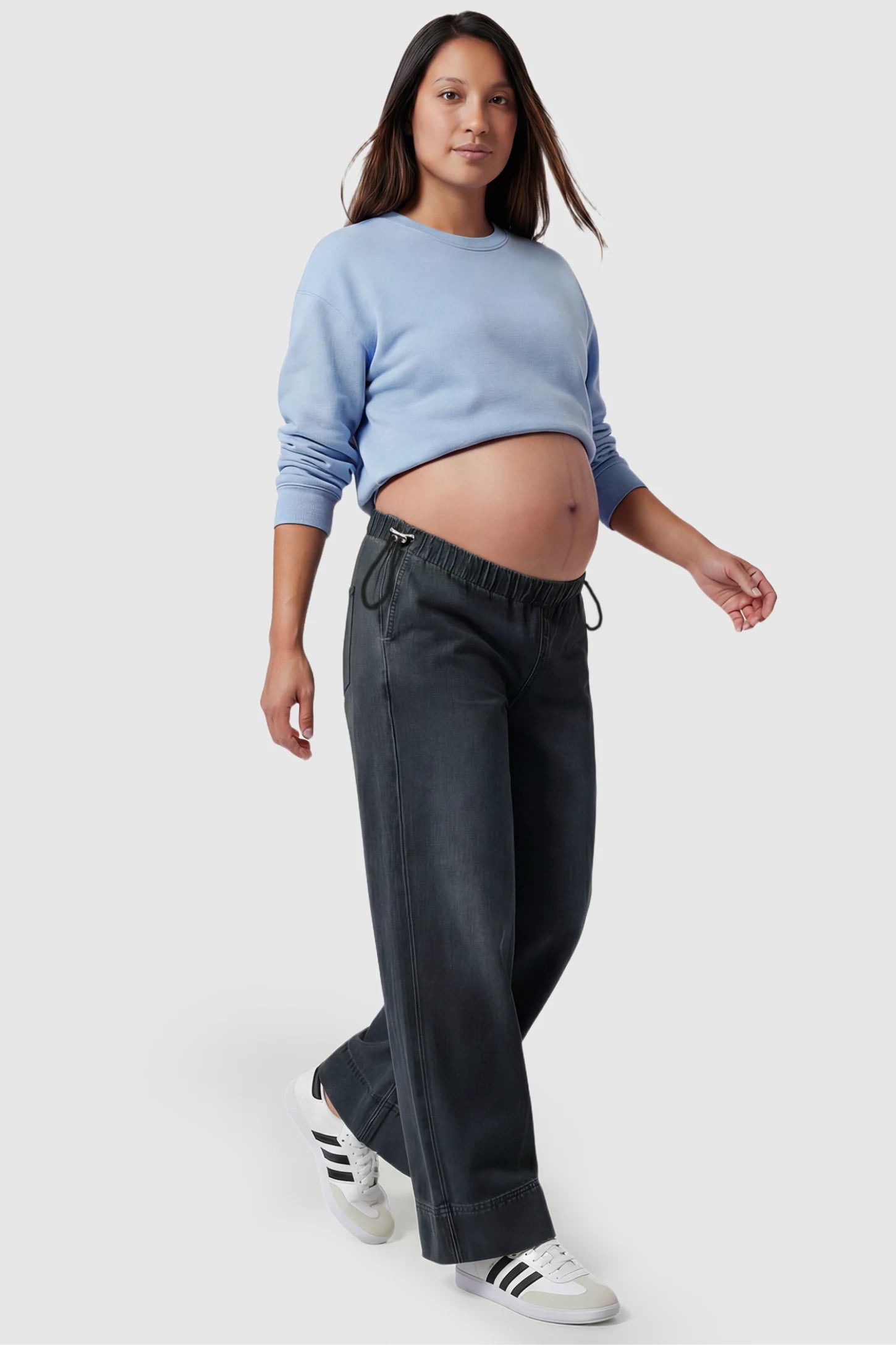 Drawstring Wide-Leg Maternity Jeans in black featuring adjustable waist and relaxed full-length silhouette on pregnant model showing front.