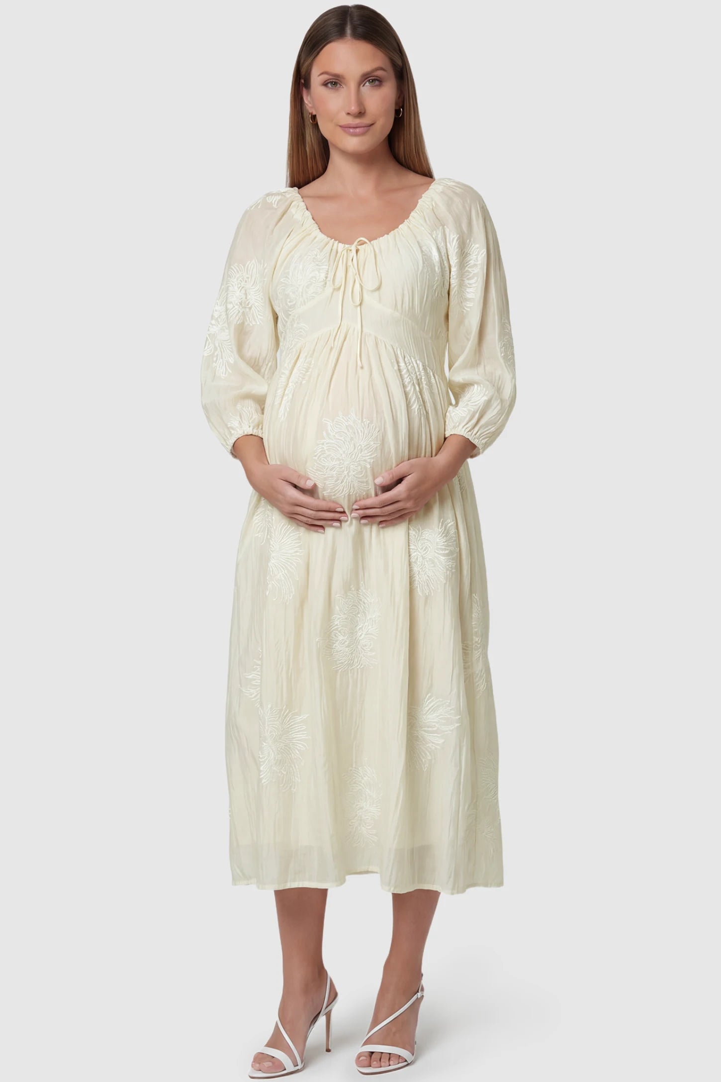 Embroidered floral gathered tie front maternity midi dress in pale yellow with delicate floral embroidery, front view on pregnant model