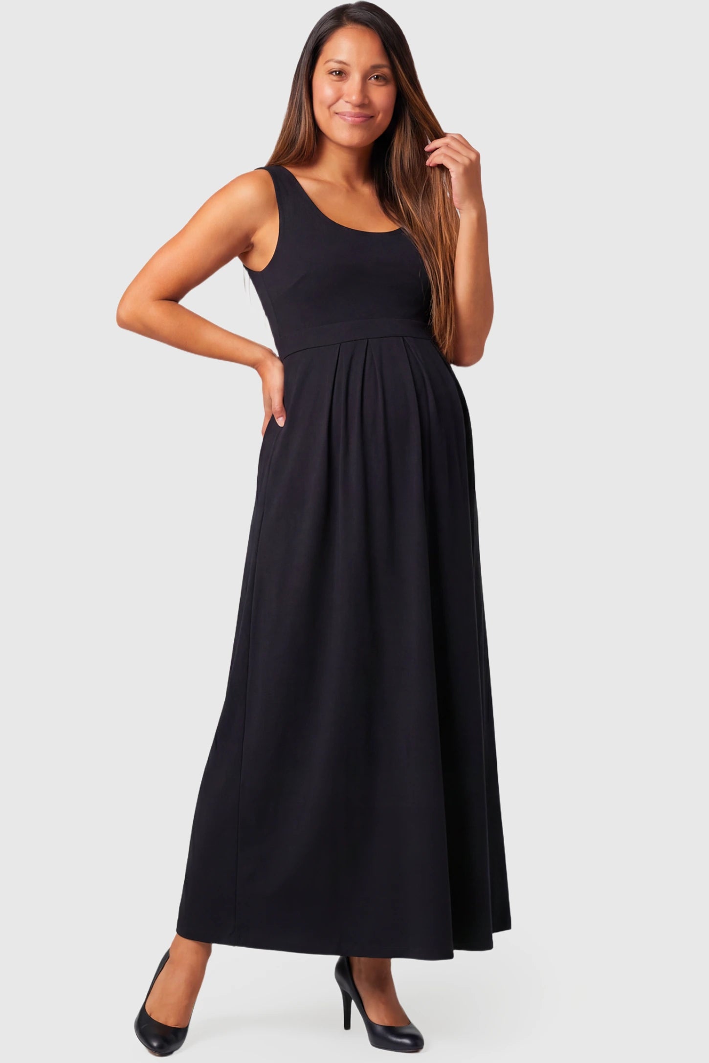 Sleeveless Empire Waist Maternity & Nursing Maxi Dress in black featuring scoop neck, fitted bodice, and flowing A-line silhouette on a pregnant model.
