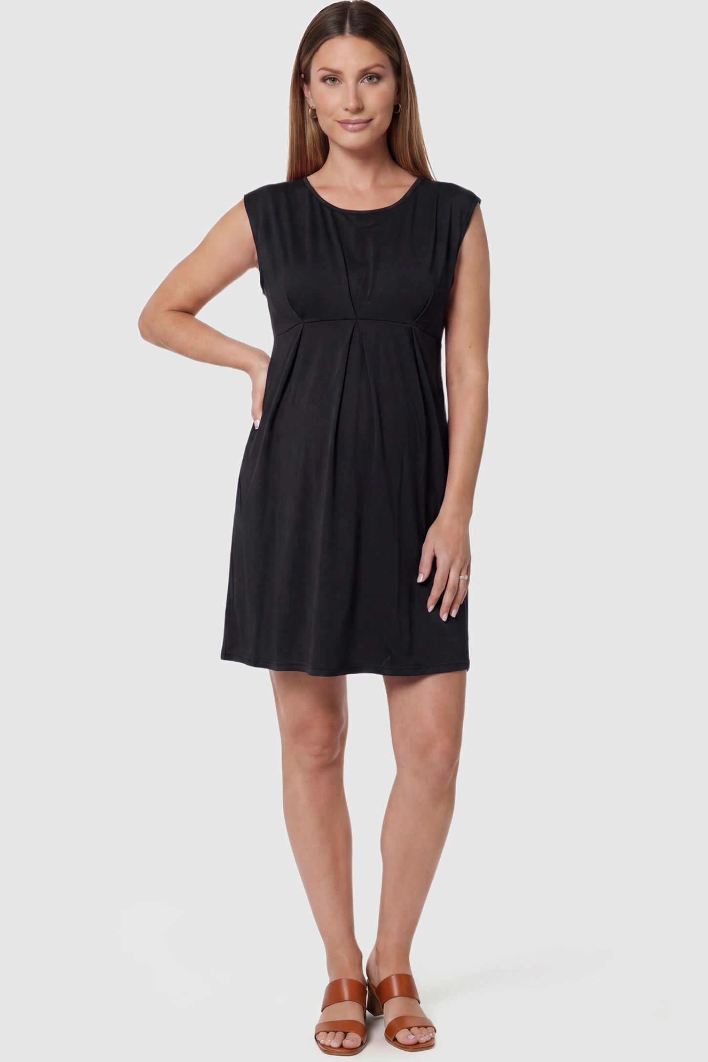 Sleeveless empire waist maternity short dress in black with short length and sleeveless design, front view on pregnant model