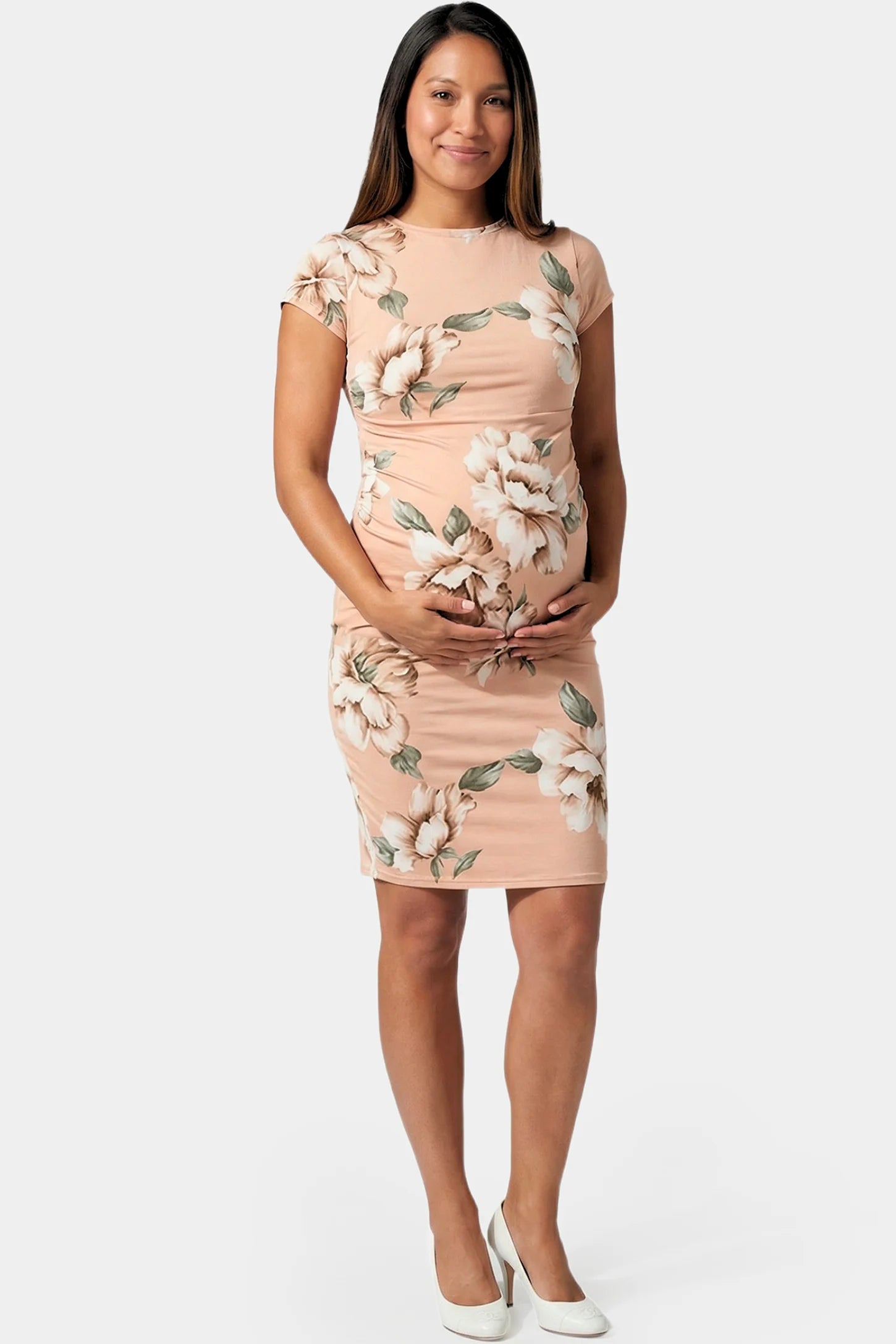 Floral Ruched Bodycon Maternity Short Dress in pink floral featuring side ruching on pregnant model.