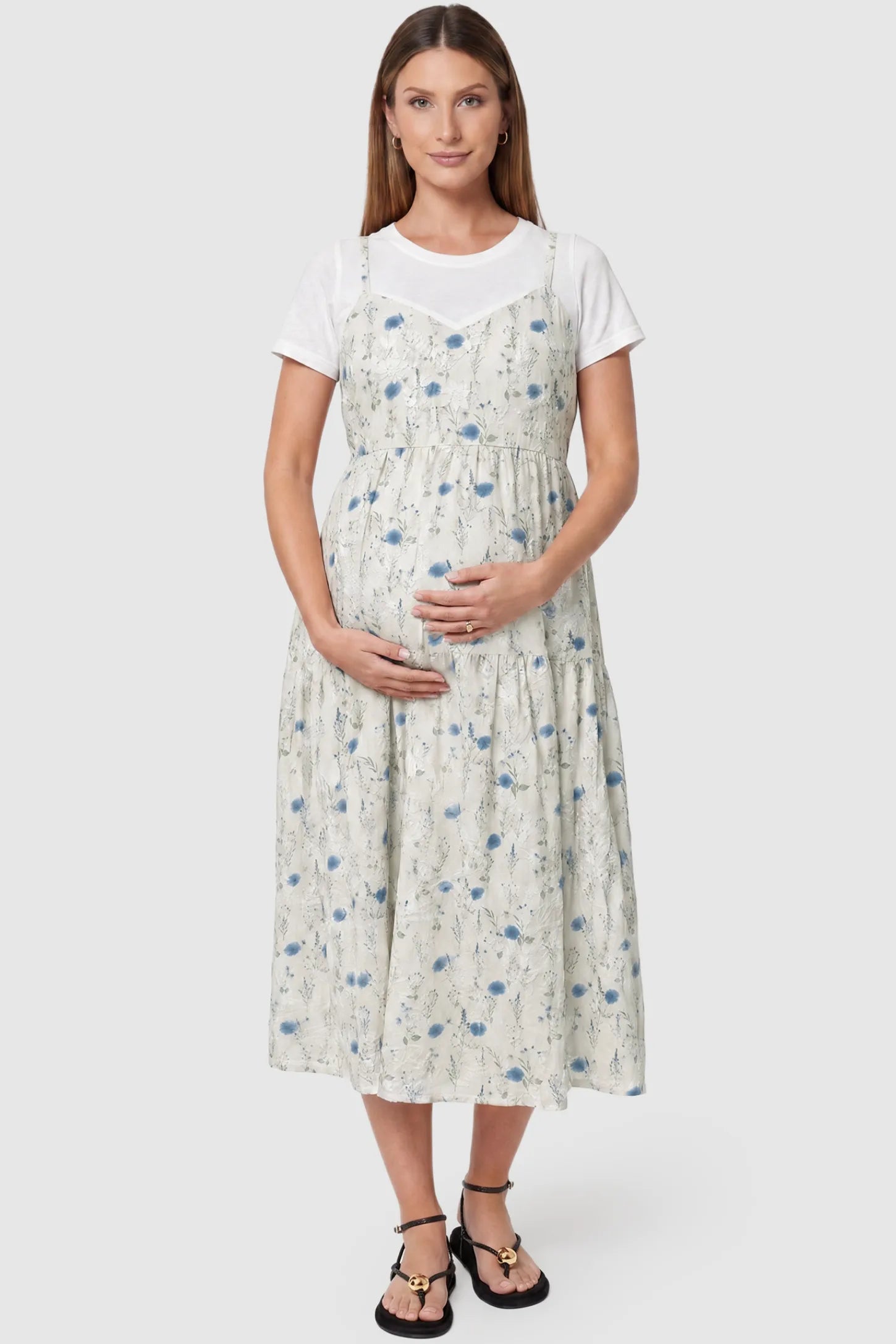 Floral print round neck layered skirt maternity midi dress in blue with elegant layered floral design, front view on pregnant model