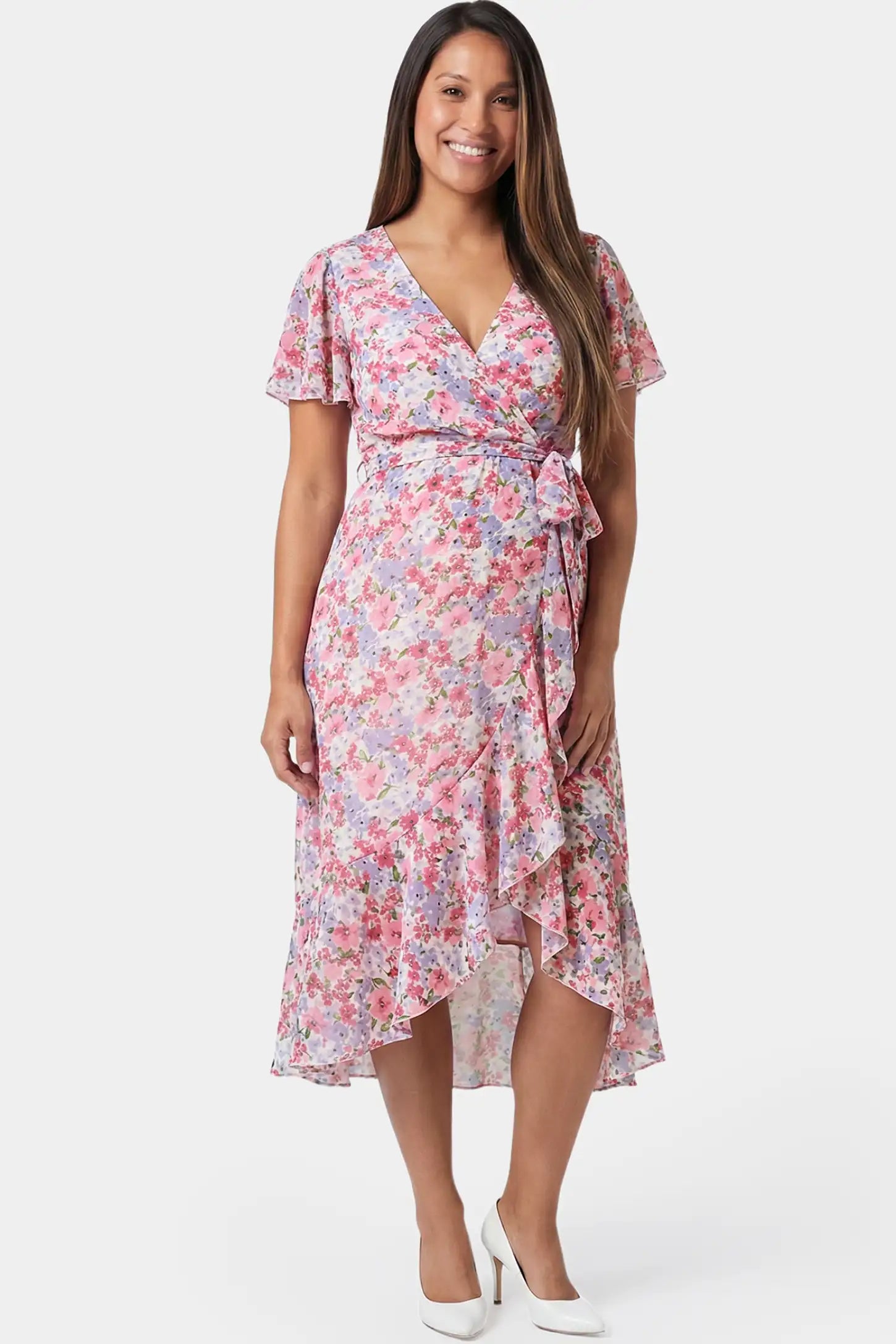 Floral V-neck ruffled hem midi maternity dress in pink featuring V-neckline and tie waist in full body front view on a pregnant model