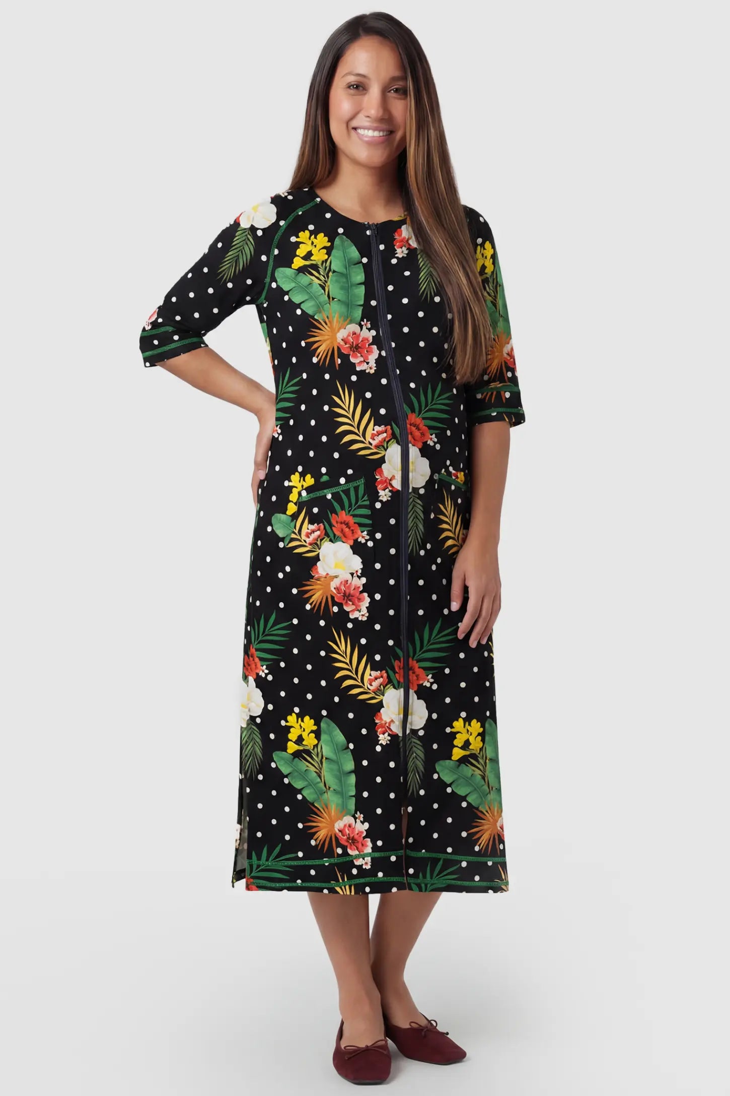 Front-Zip Floral & Polka Dot Maternity & Nursing Midi Lounge Dress in black with white dots and green floral print featuring full zipper closure and A-line silhouette on pregnant model.
