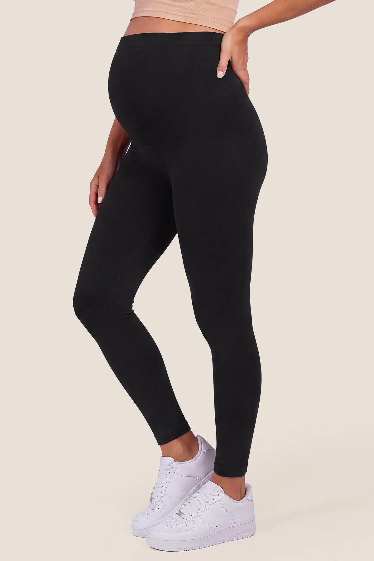 High Waist Full Length Maternity Leggings in Black featuring seam-contoured side fit, full length leg coverage, and supportive over-the-belly panel on a pregnant model, side view.