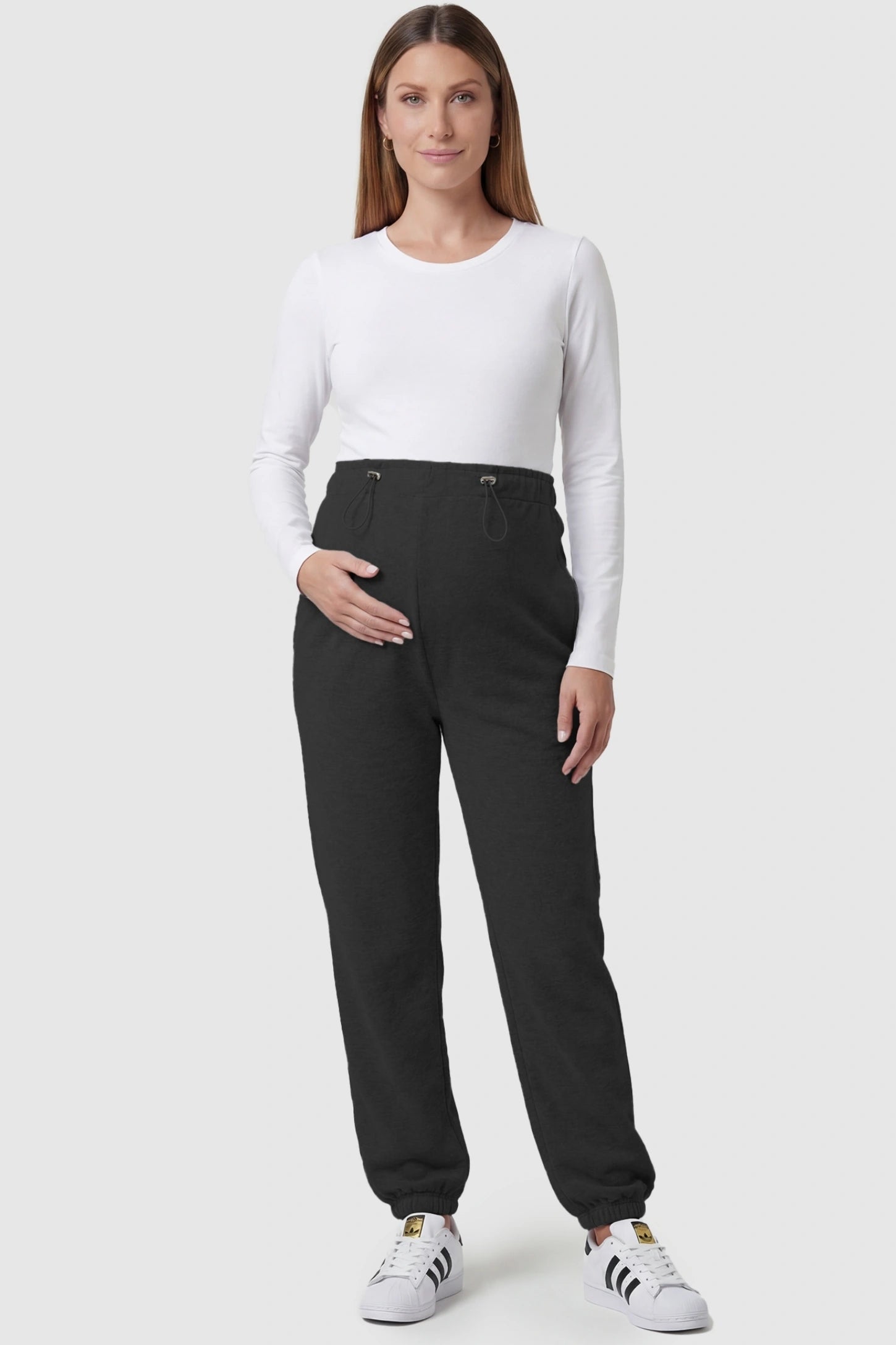 High-rise drawstring waist loose fit jogger maternity pants in black with relaxed fit, full body on pregnant model