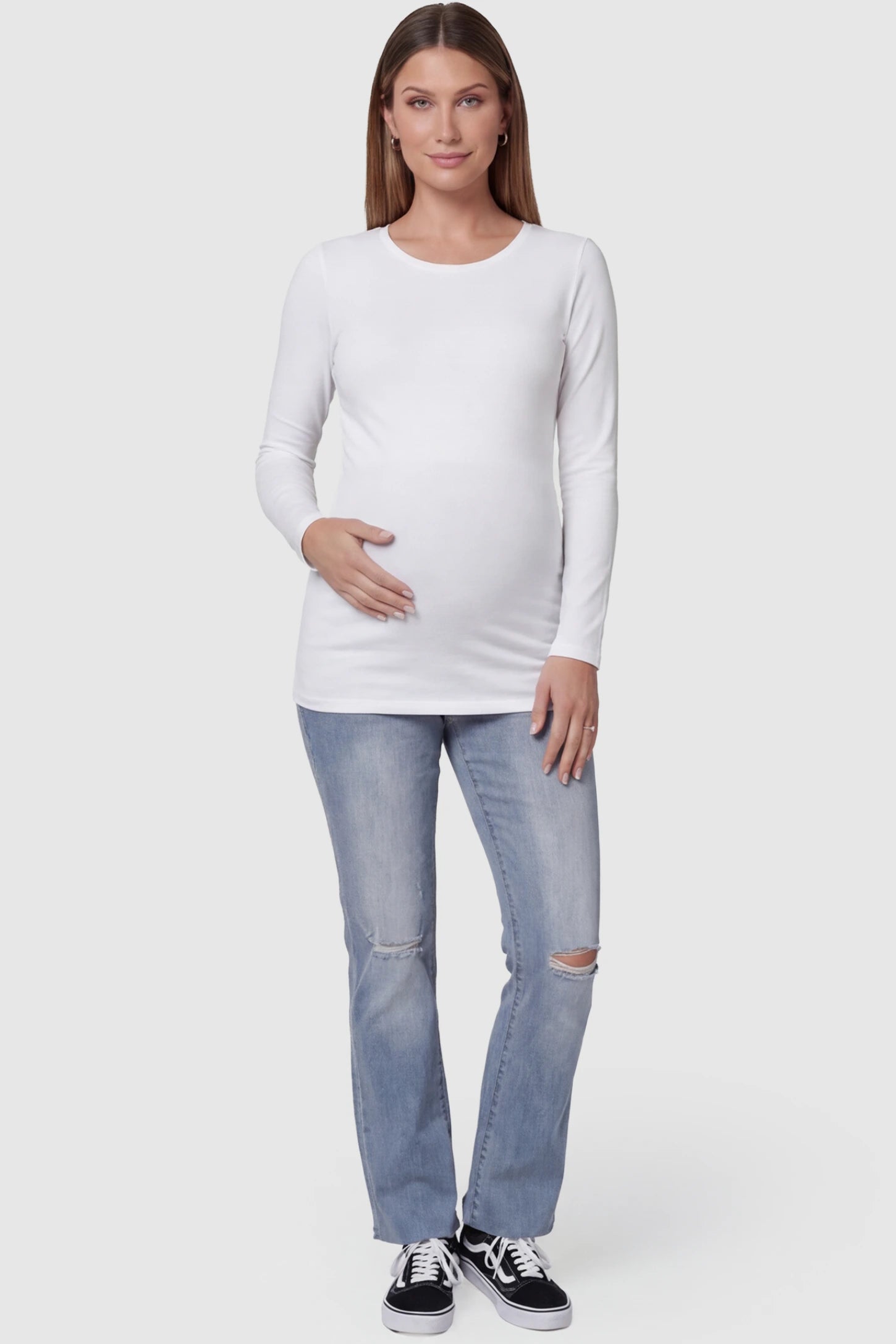 Knee slit wide leg maternity jeans in blue with distressed knee slit detail, front view on pregnant model