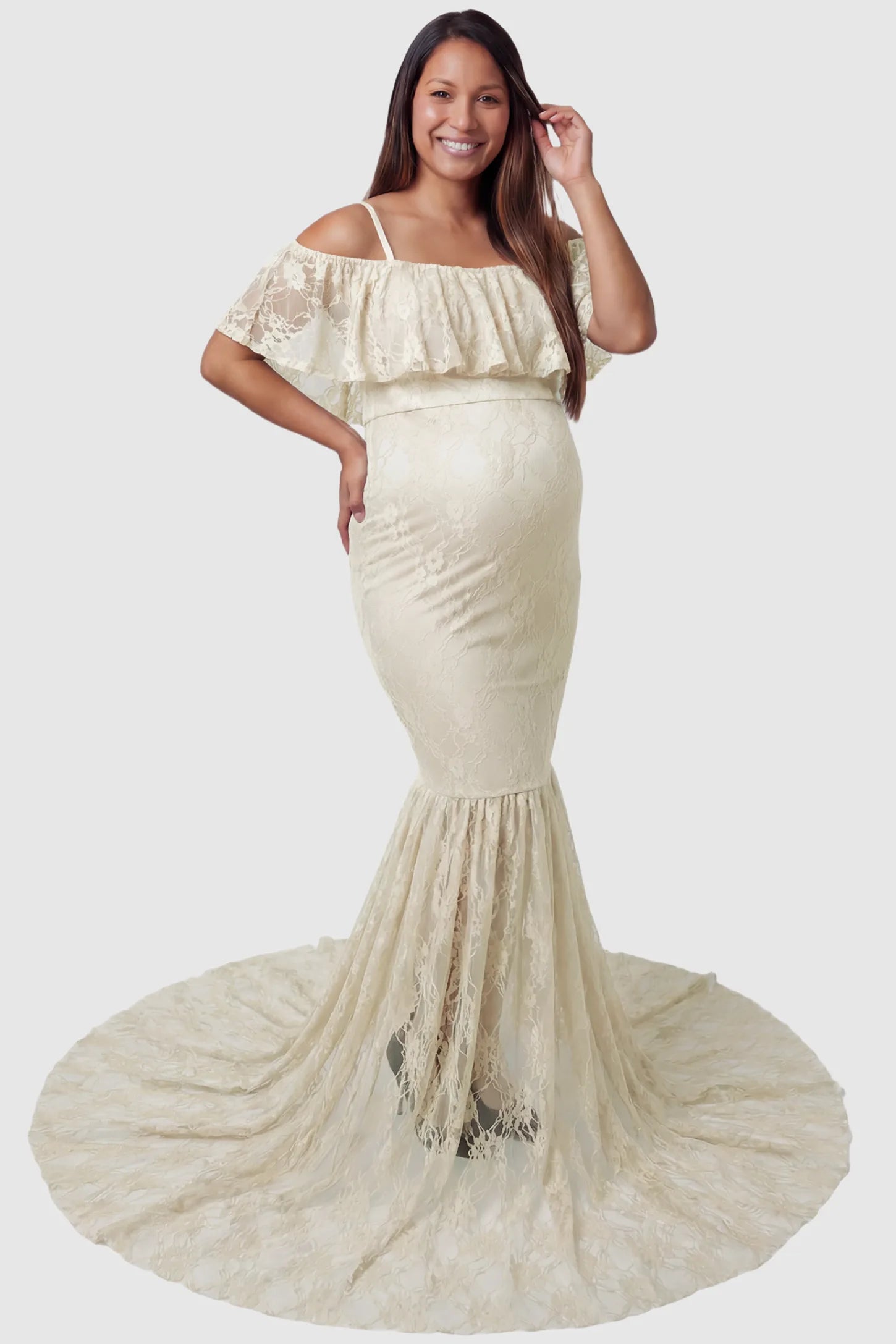 Lace off-shoulder maternity gown in apricot featuring ruffle neckline, mermaid silhouette, and extended lace train on pregnant model. front view