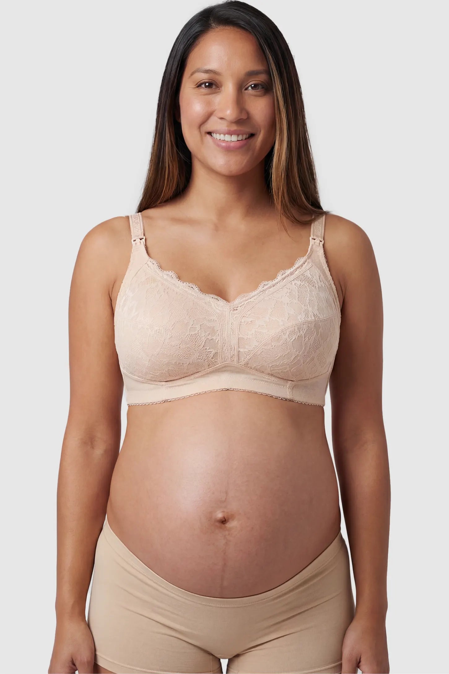 Wireless Lace Maternity Nursing Bra in beige featuring scalloped lace neckline, and full-cup coverage on pregnant model.