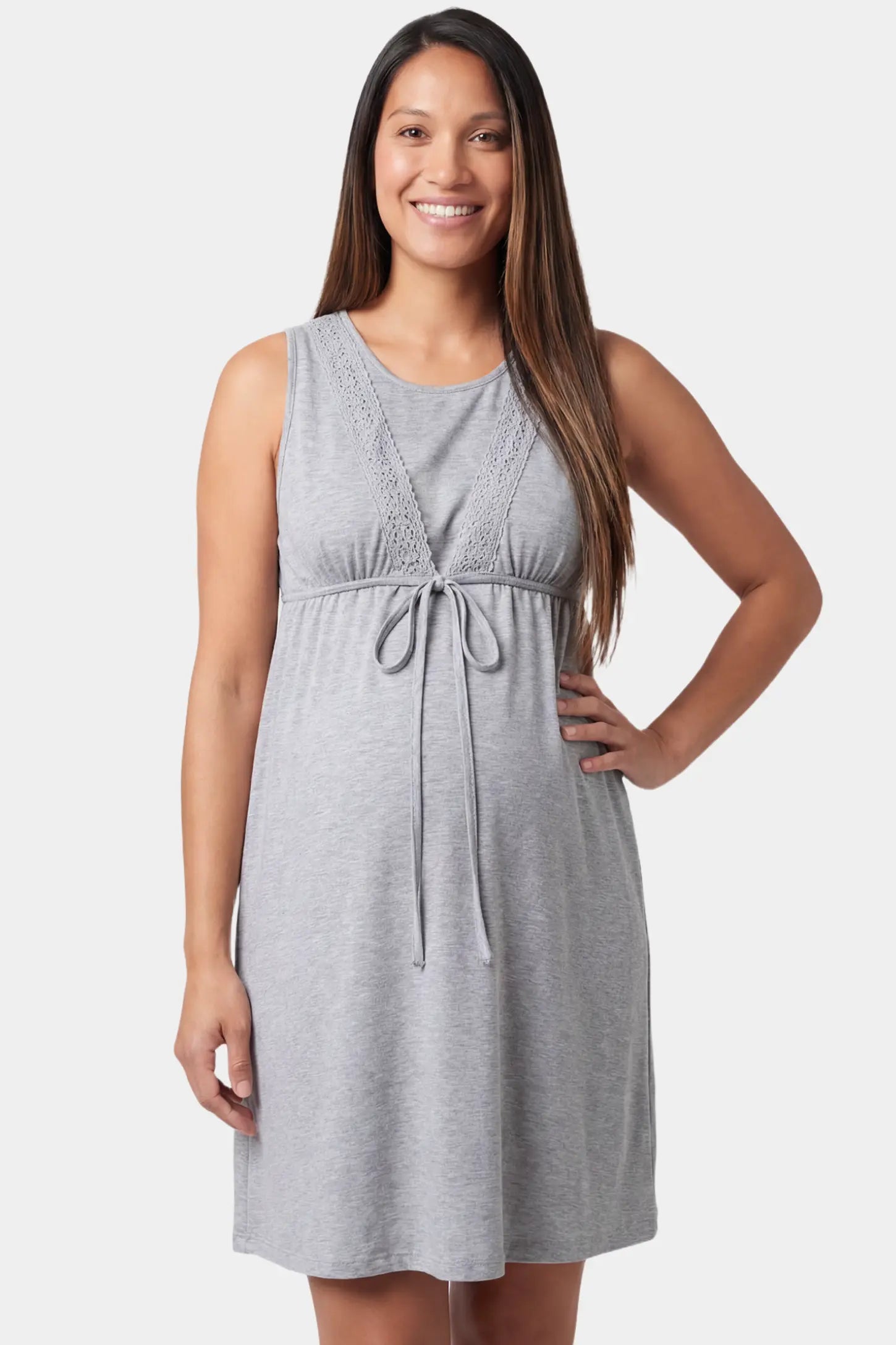 Sleeveless round neck tie-front short maternity and nursing dress in gray featuring tie-front detail in front view on a pregnant model