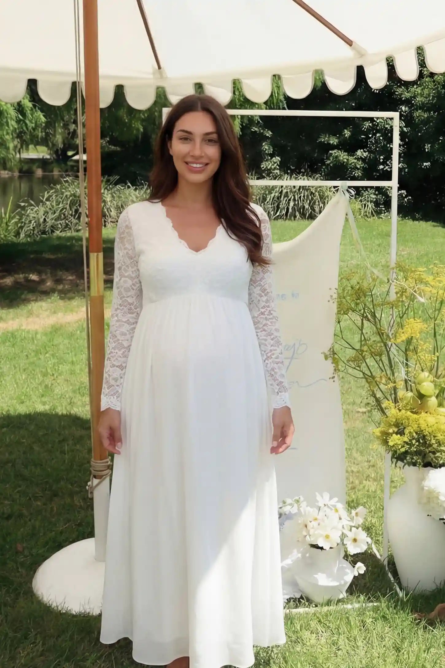 Lace & Chiffon Empire Waist Maternity Wedding Gown in White featuring a V-neck and long sleeves on a pregnant model.