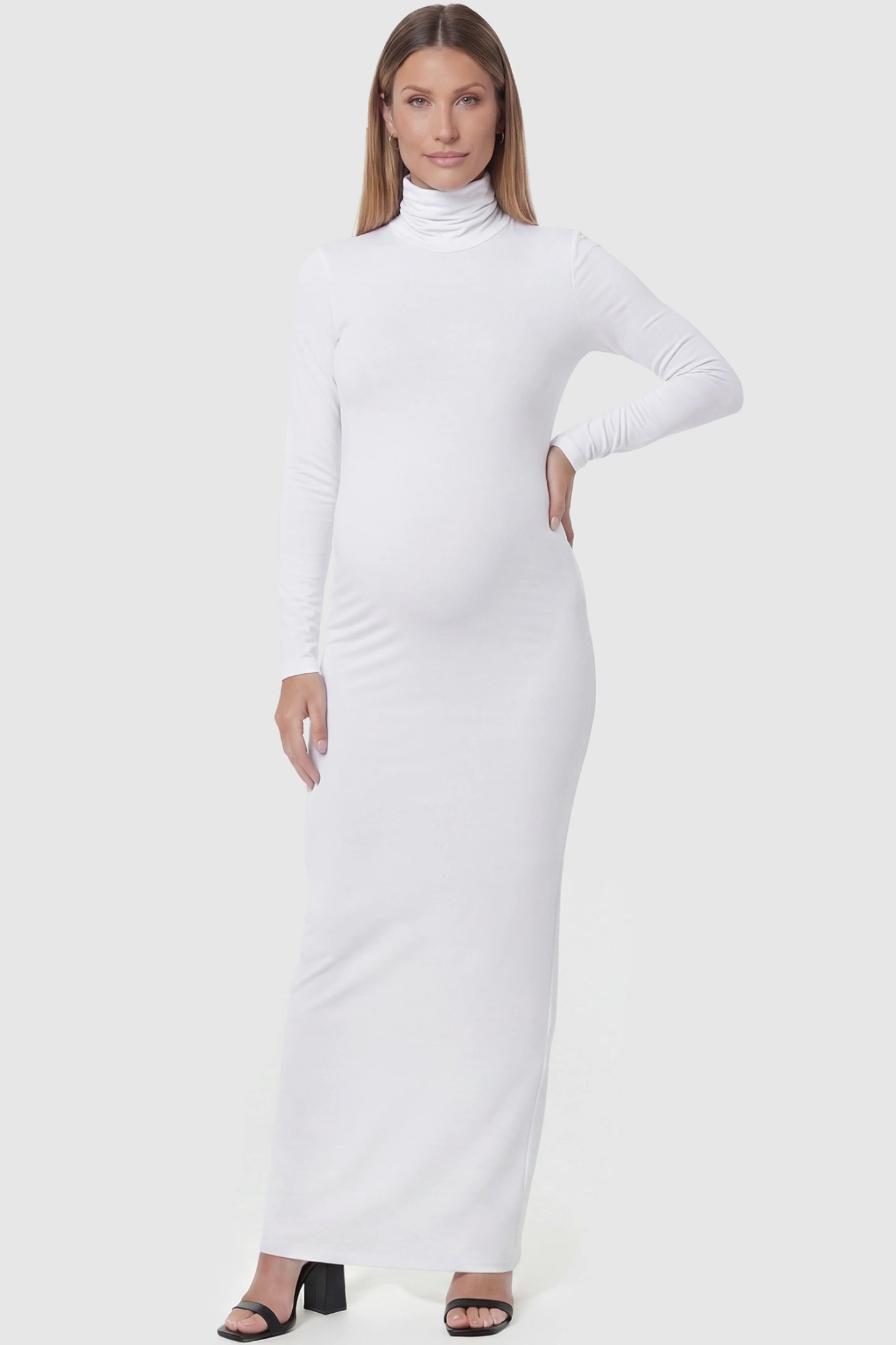 Fitted long sleeve mock neck maxi maternity dress in white with mock neckline, front view on pregnant model