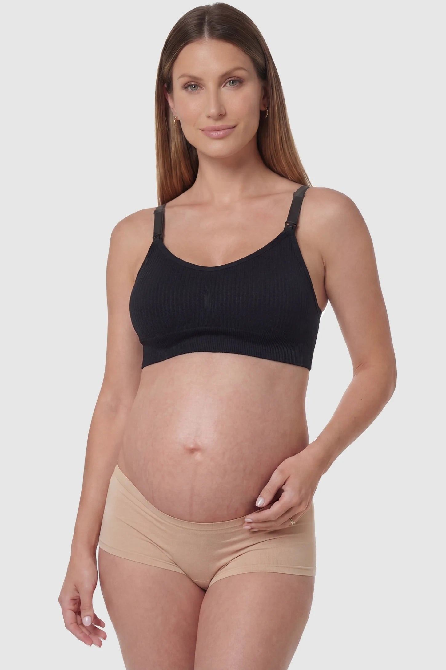 Full-flap seamless top-opening nursing bra in black with 3D support, front view on pregnant model