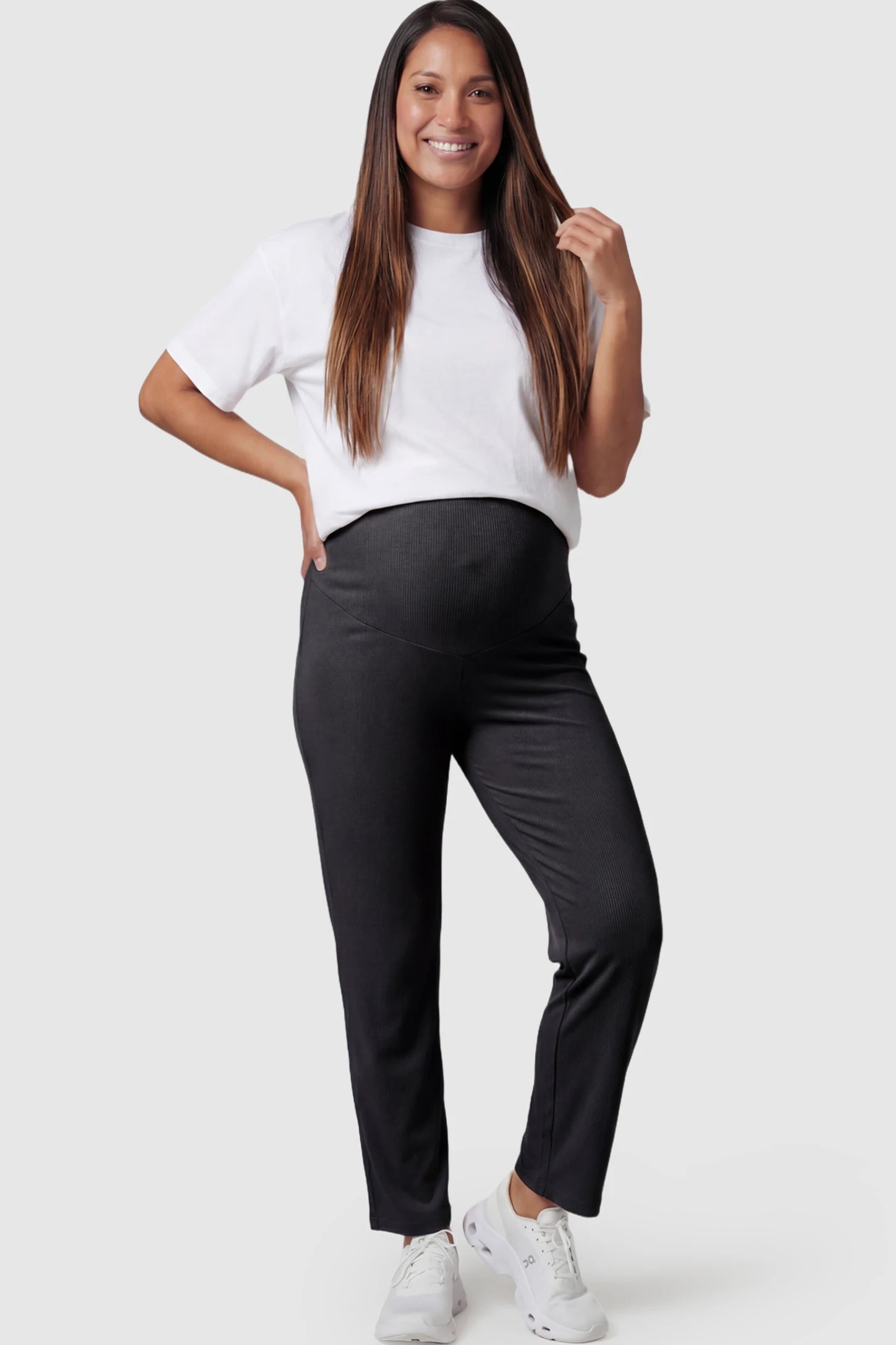 Straight Leg Maternity Pants in black featuring an adjustable elastic waist on a pregnant model.