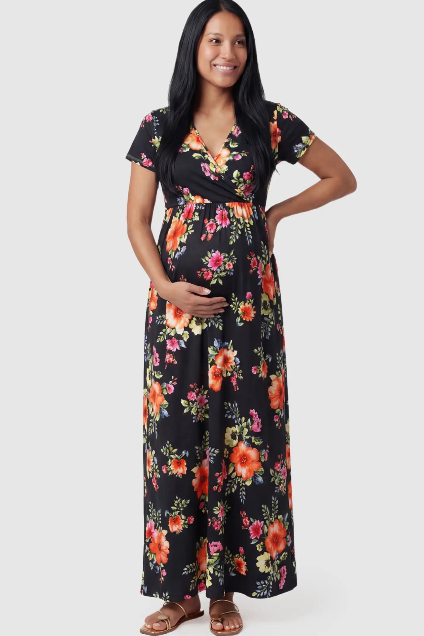 Floral Print V-Neck Maternity Maxi Dress in Black featuring a vibrant floral pattern on a pregnant model.