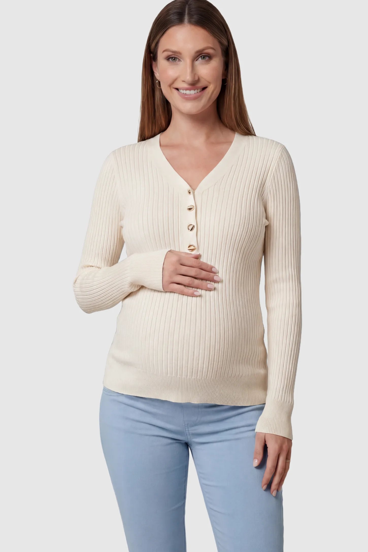 Ribbed Maternity Henley Top in Apricot featuring a functional button placket and vertical rib knit on a pregnant model.