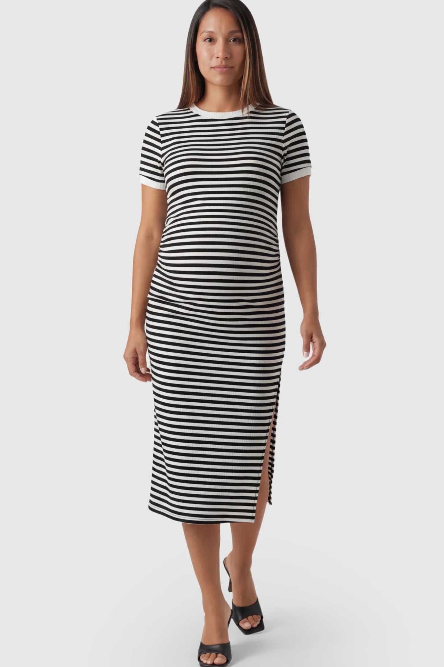 Striped Side-Slit Bodycon Maternity Midi Dress in Black and White featuring a side slit on a pregnant model.