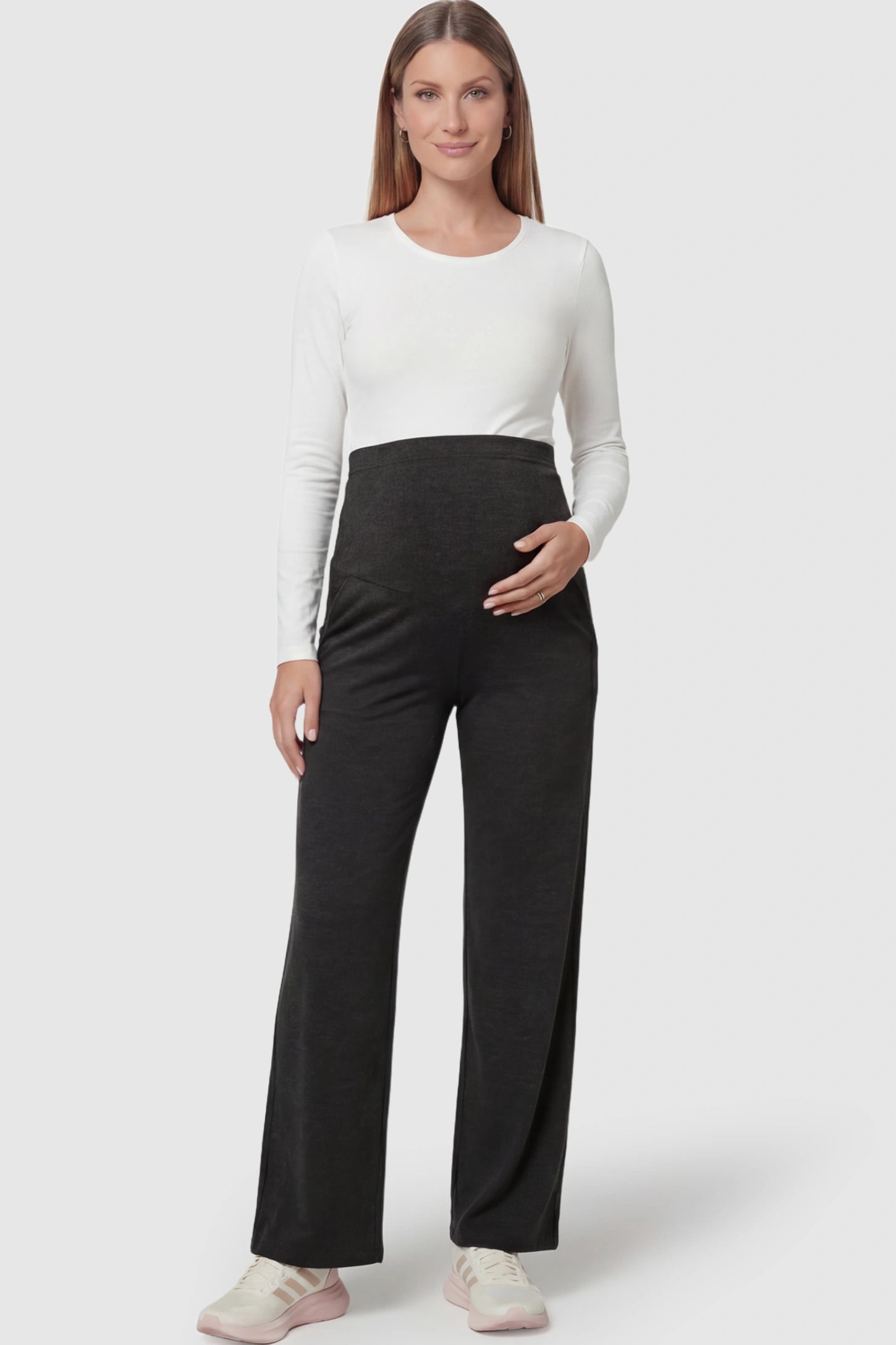 Fold-Over Waistband Wide Leg Maternity Pants in Black featuring a versatile high-waist fit on a pregnant model facing front.
