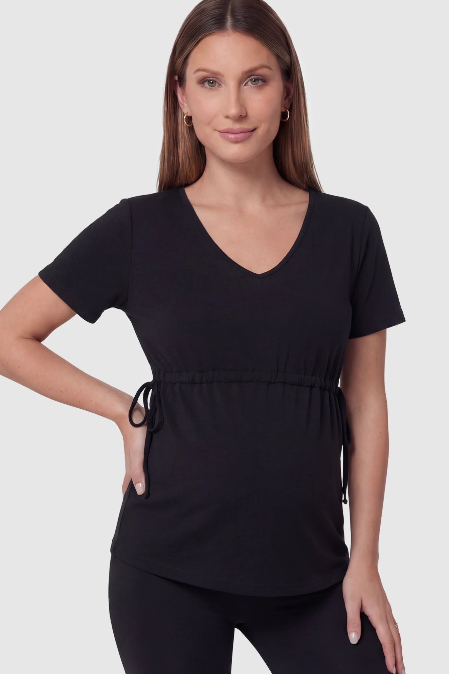 Cinched Waist Short Sleeve Maternity Tunic in Black featuring a flattering empire waist on a pregnant model in front view.