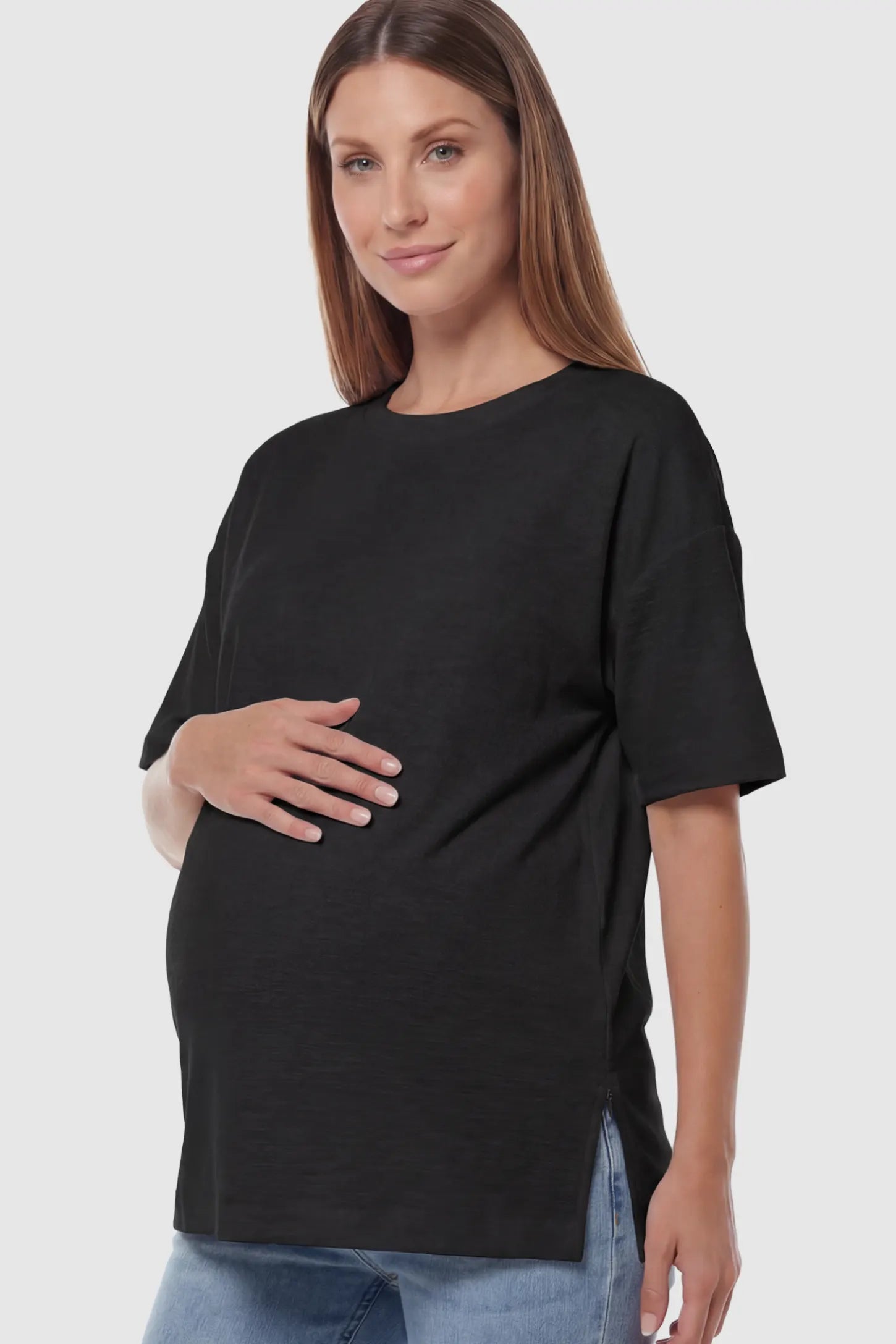 Textured Oversized Short Sleeve Maternity T-Shirt in Black featuring a side-slit hem and drop shoulders on a model.