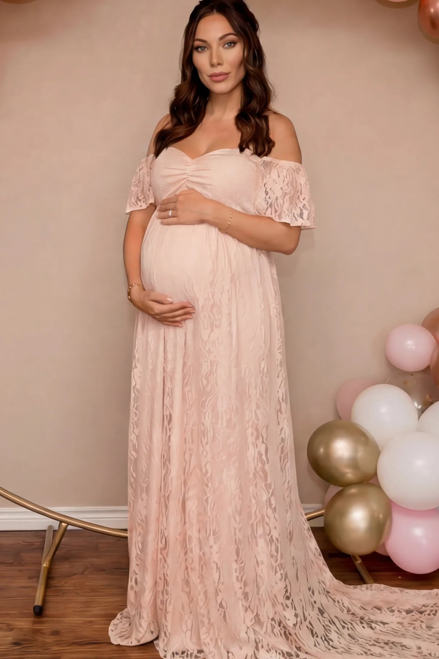 Floral Lace Off The Shoulder Maternity Maxi Dress featuring a ruched bust in Pink on a pregnant model.