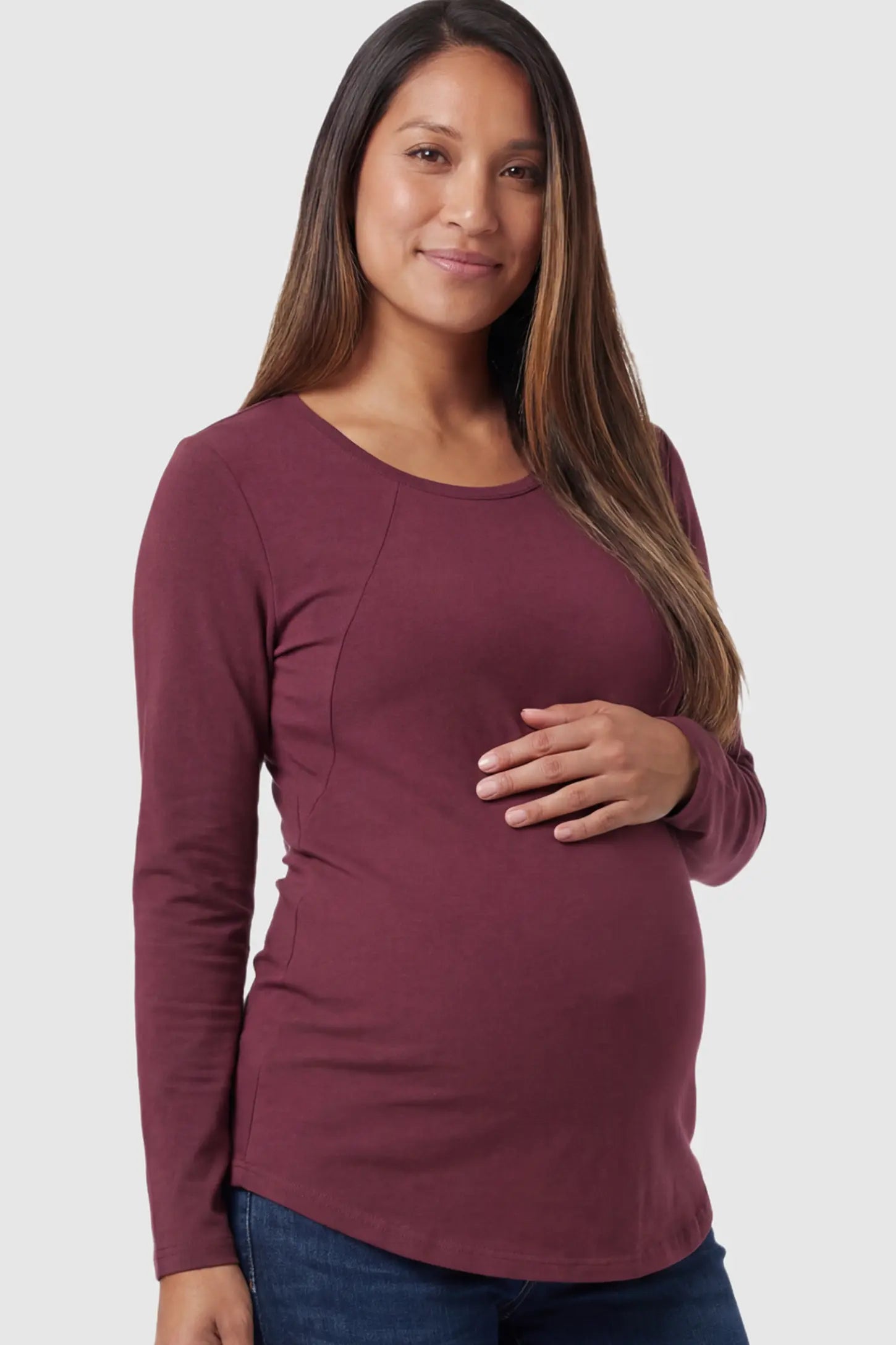 Solid Crew Neck Long Sleeve Maternity & Nursing Top in Wine Red featuring a discreet lift-up breastfeeding access on a model.