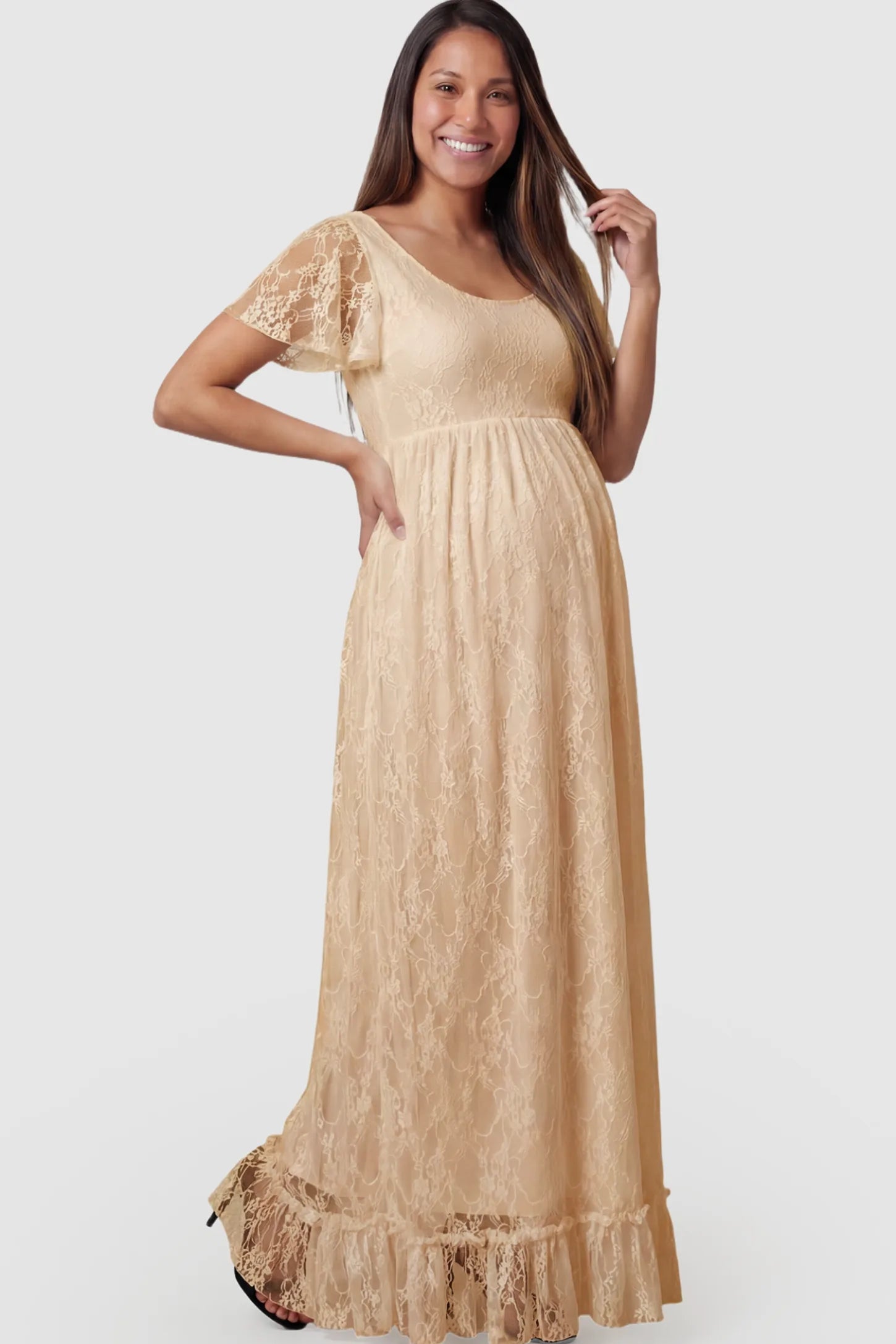 Floral Lace Flutter Sleeve Maxi Maternity Dress in Champagne featuring delicate lace and an empire waist on a pregnant model.