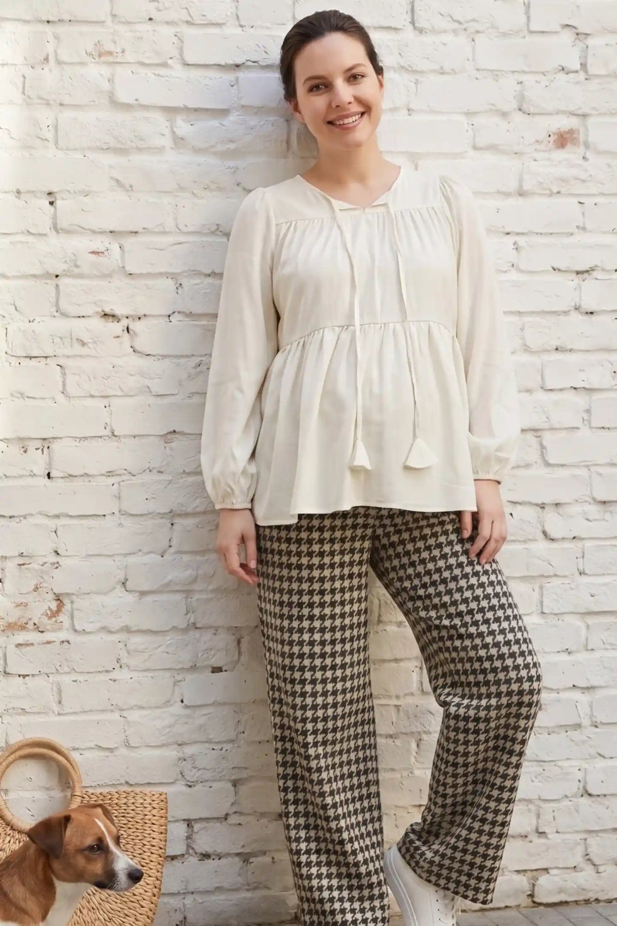 Tie-front tassel long sleeve peplum maternity blouse in pale yellow with tie-front tassel detail, front view on pregnant model
