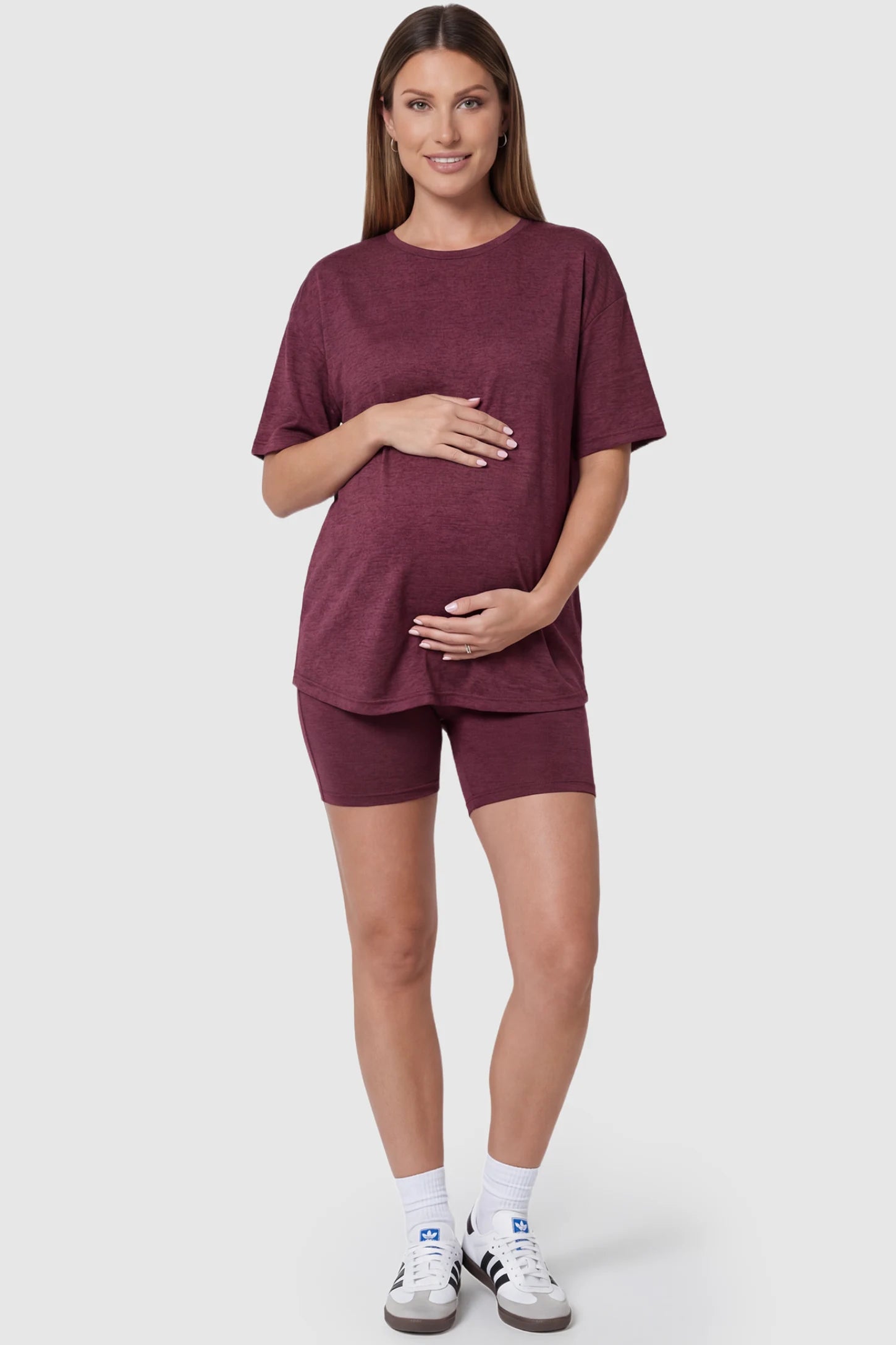 Stretch Oversized Tee & Biker Short Maternity Lounge Set in burgundy featuring relaxed-fit T-shirt and mid-thigh fitted biker shorts on pregnant model.