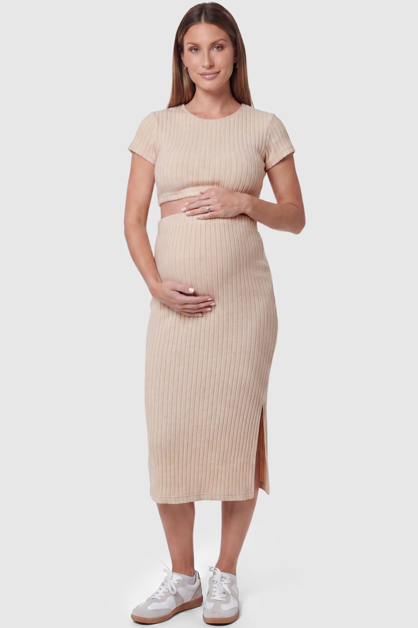 Ribbed Bodycon Crop Top & Skirt Maternity Set in beige featuring a fitted ribbed knit silhouette with side slit on a pregnant model front view.