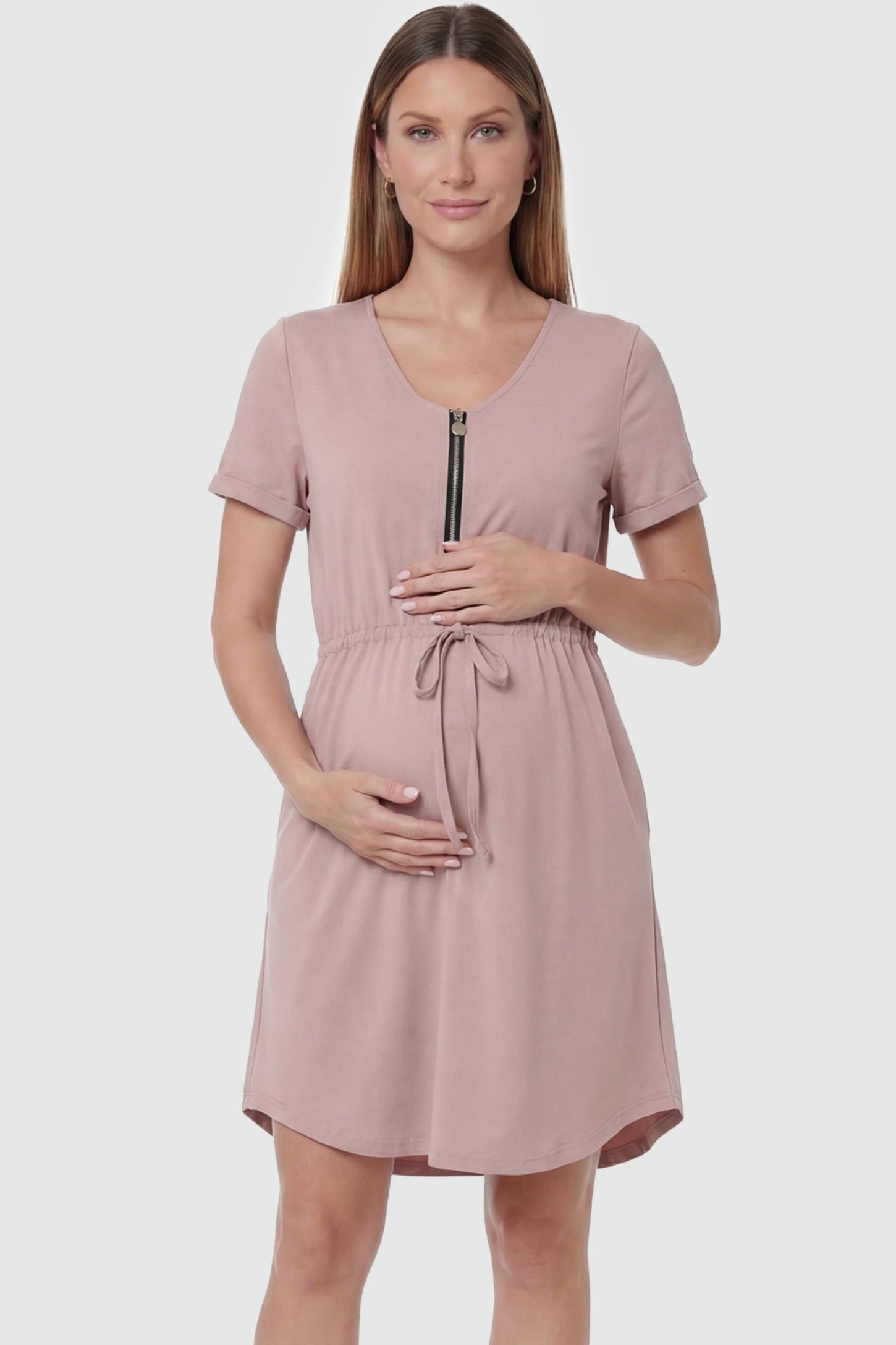 Scoop neck short sleeve maternity and nursing dress in rose gold featuring front zipper closure in front view on a pregnant model