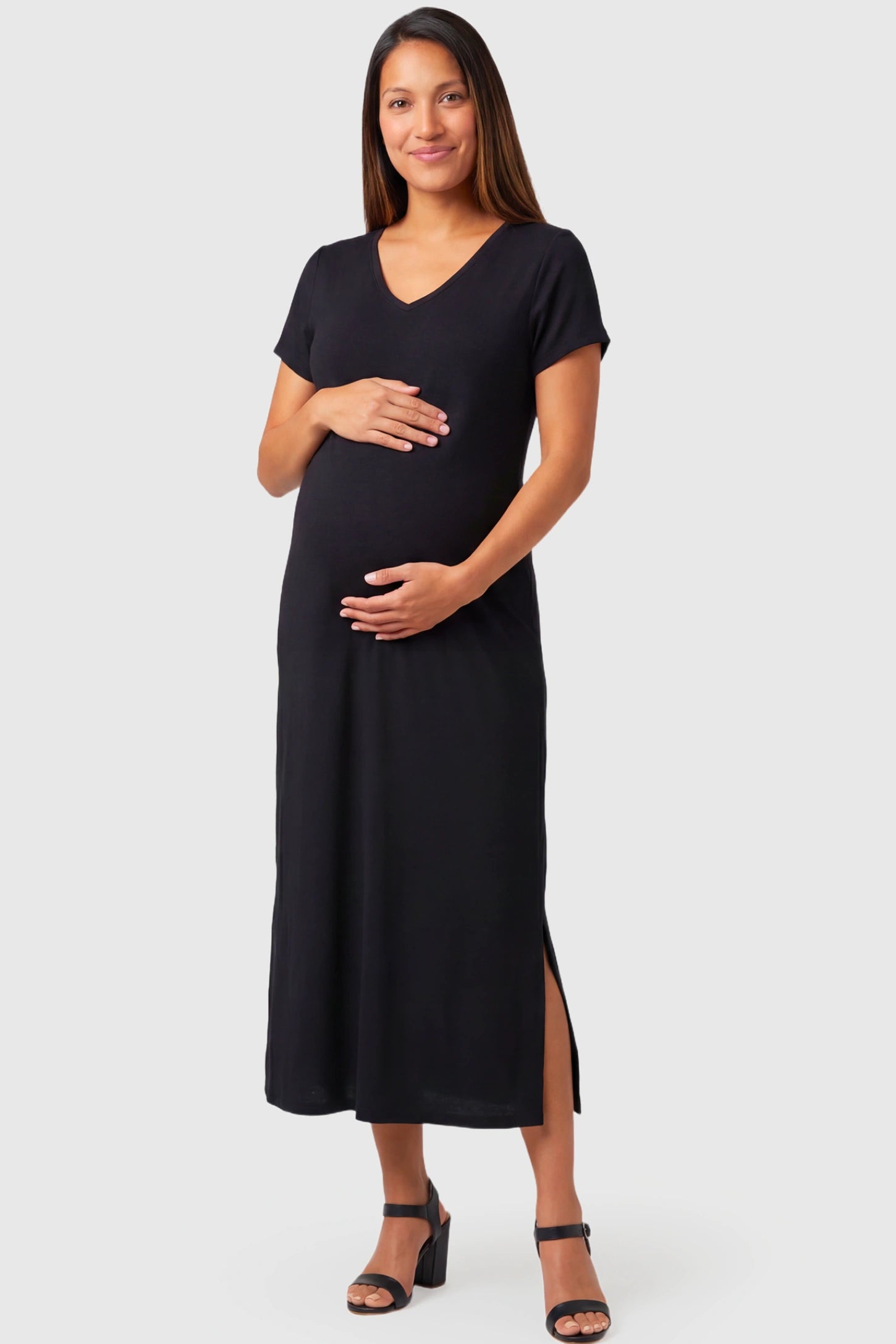 Casual V-Neck Short Sleeve Maternity Midi Dress in black featuring a relaxed straight fit and side slit on a pregnant model.