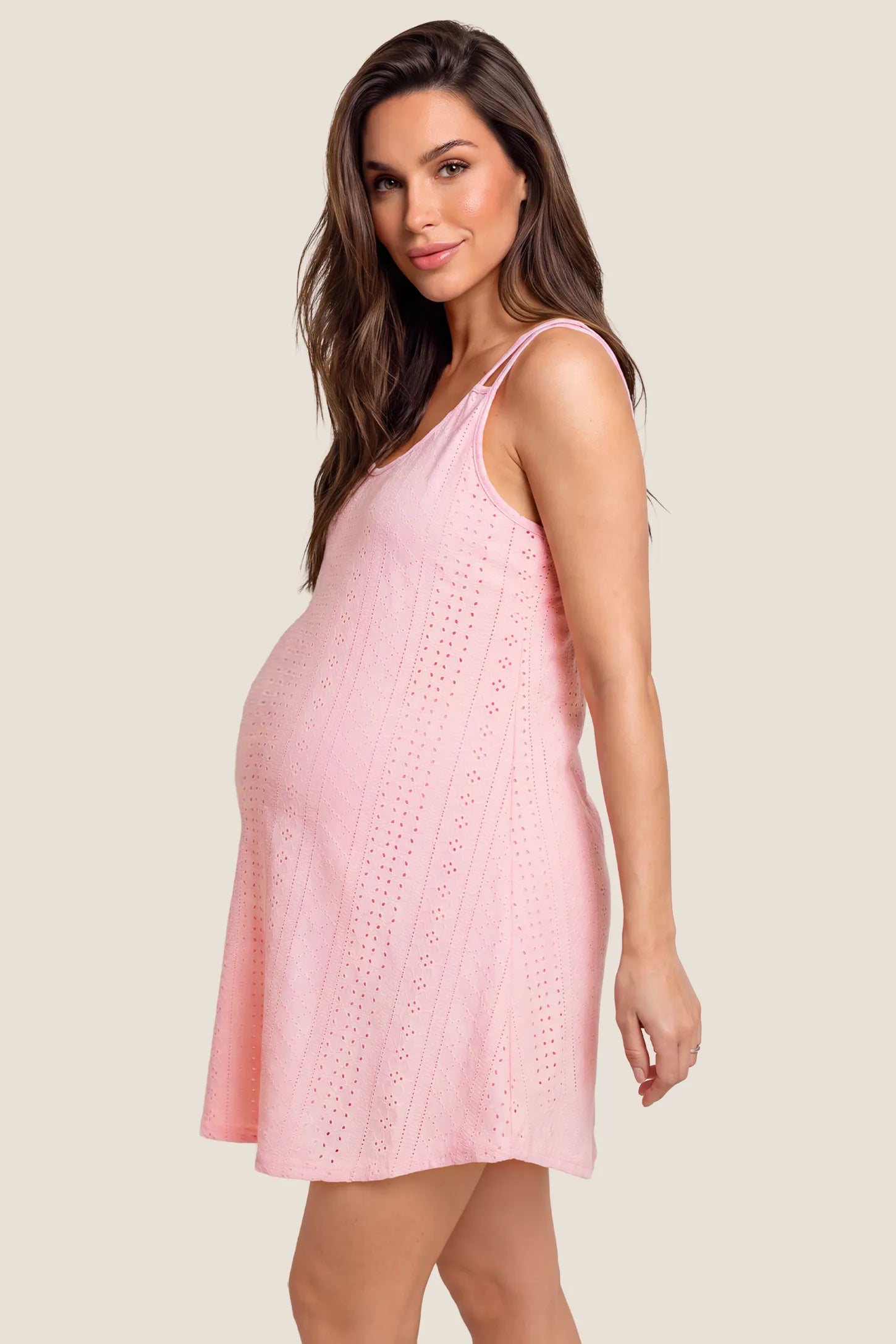 Sleeveless Knit A-Line Maternity Nightgowns in Pink featuring side bump space, flowing A-line silhouette, and comfortable stretch fit on a pregnant model, standing side profile view.