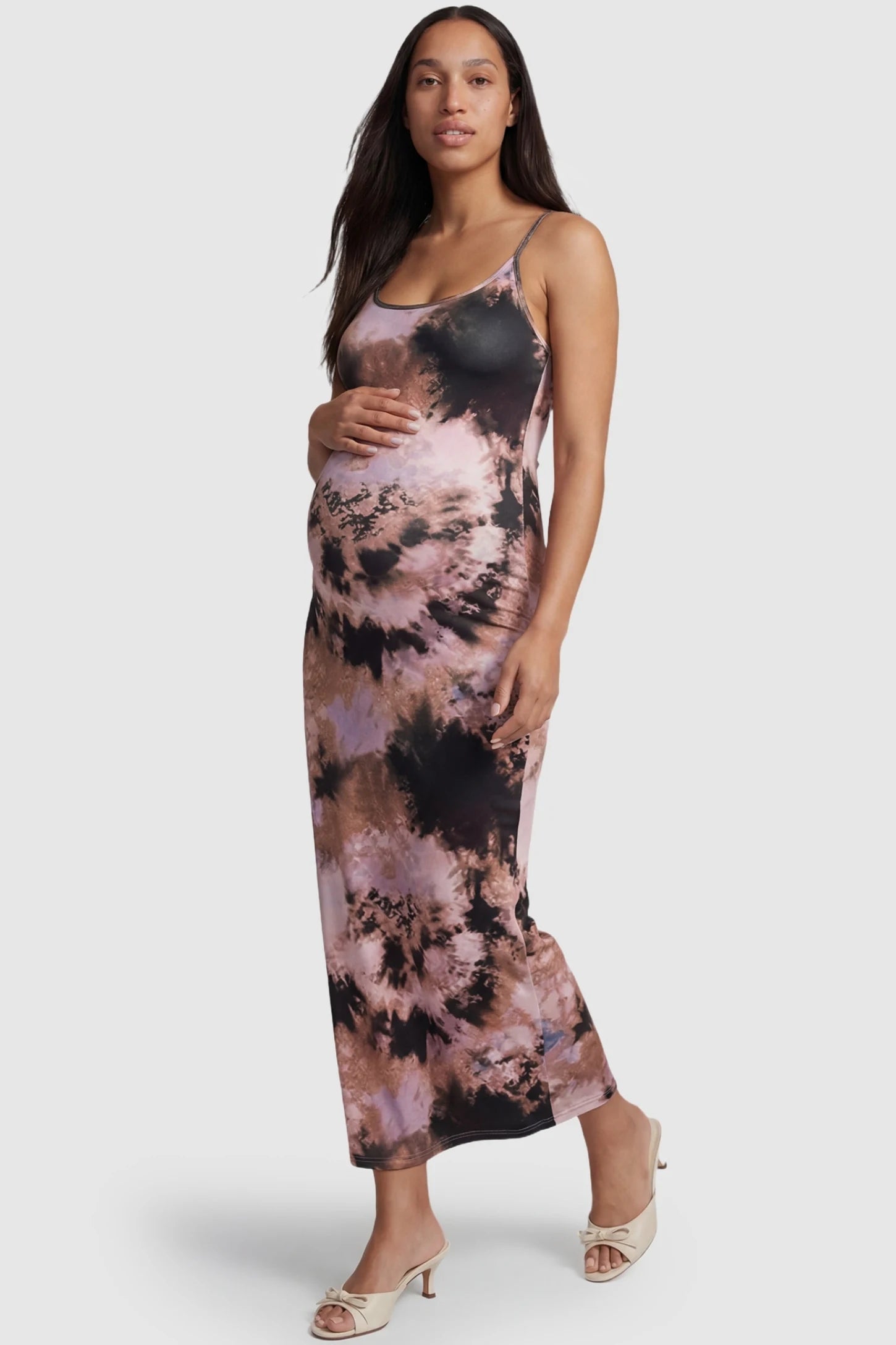 Tie Dye Spaghetti Strap Bodycon Maternity Dress in Pinkish Tie-dye featuring a slim fitting front-facing silhouette on a pregnant model.