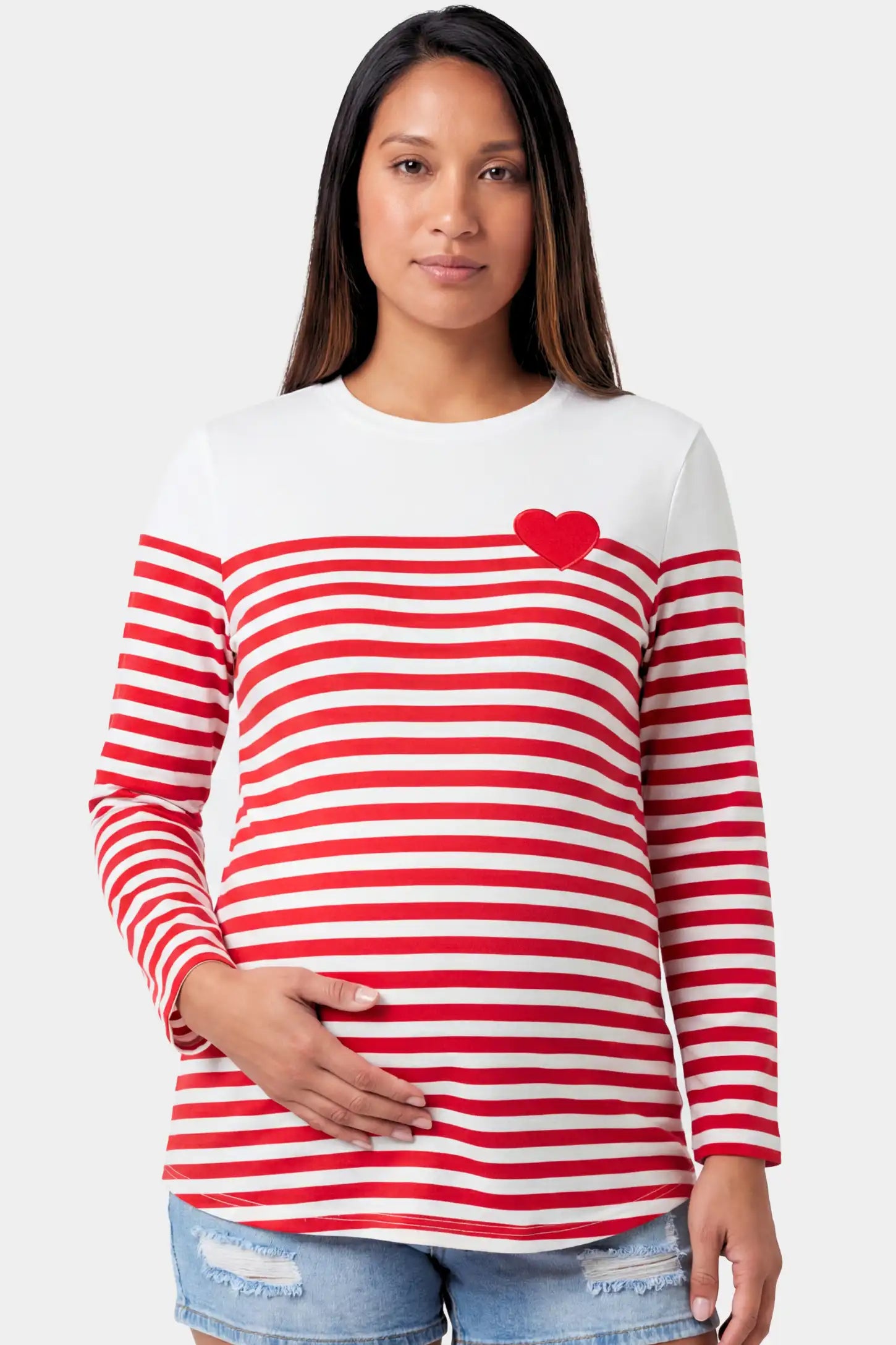 Striped Crew Neck Long Sleeve Maternity Top in red featuring a crew neck and heart detail on a pregnant model.