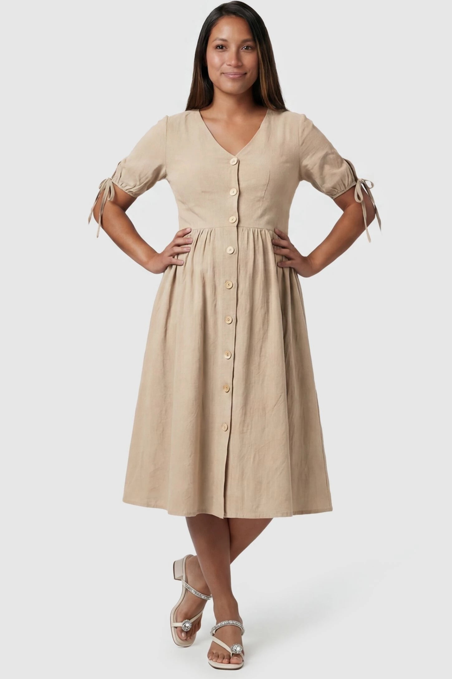 Front view Tie-Sleeve V-Neck Flared Maternity Midi Dress in Apricot featuring a button front on a pregnant model.