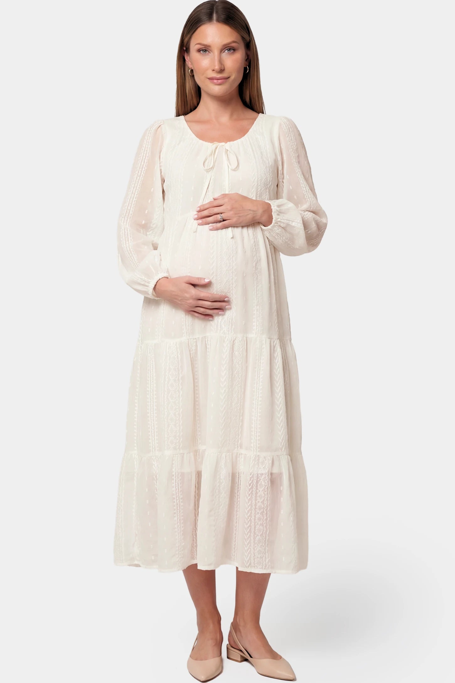 Balloon Sleeve Tiered Maternity Midi Dress in off white featuring flowy tiers and long balloon sleeves on a pregnant model.