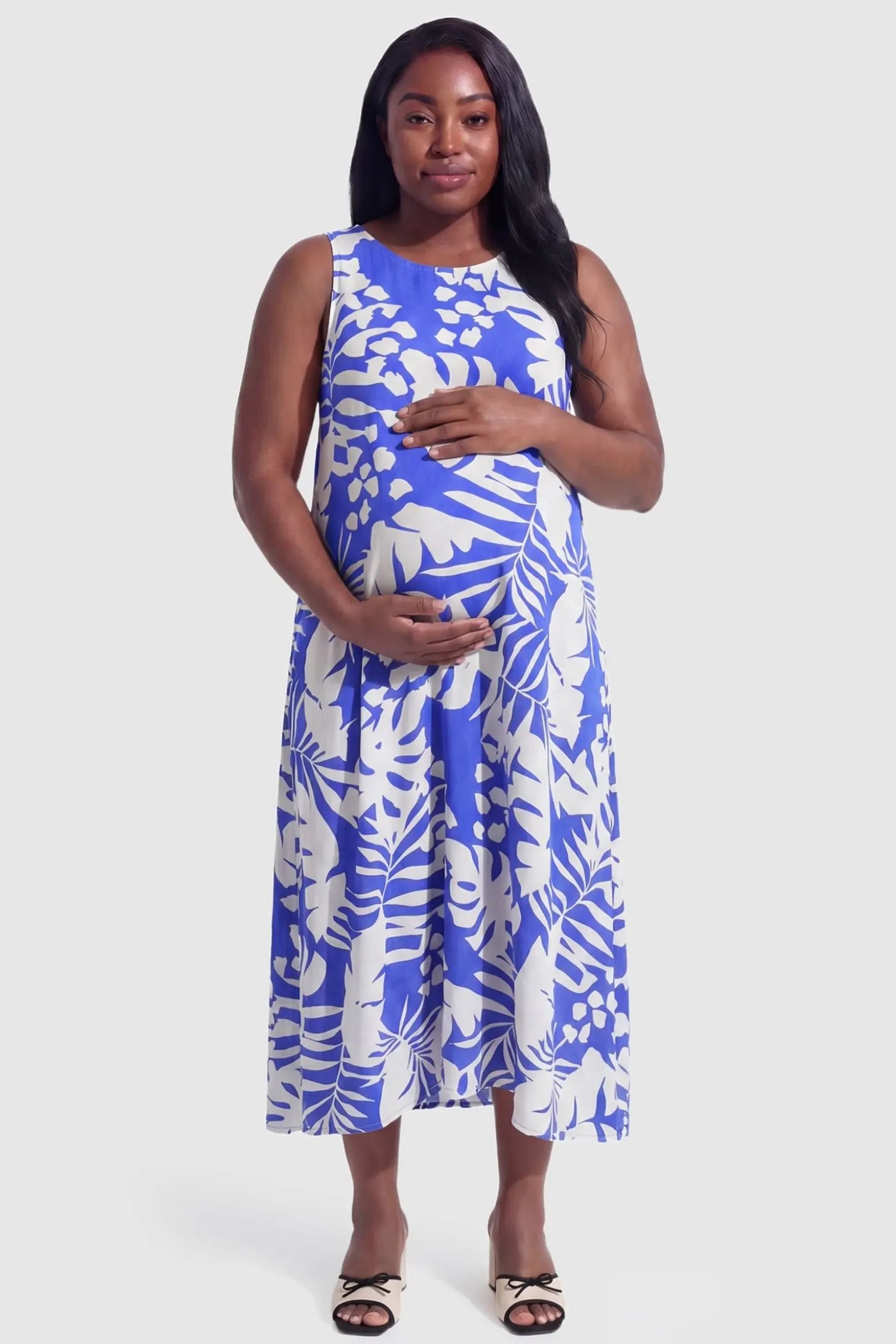 Tropical Print V-Neck Sleeveless Midi Maternity Dress in Blue featuring a relaxed A-line cut on a pregnant model.
