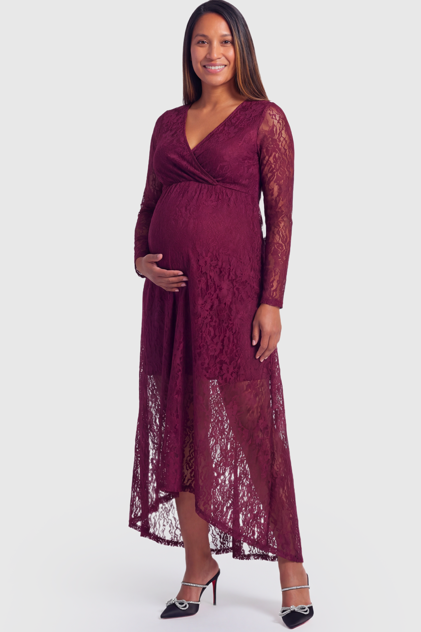 Hi-Low Hem Wrap Neck Maternity Midi Dress in wine red lace featuring long sleeves and empire waist on a pregnant model.